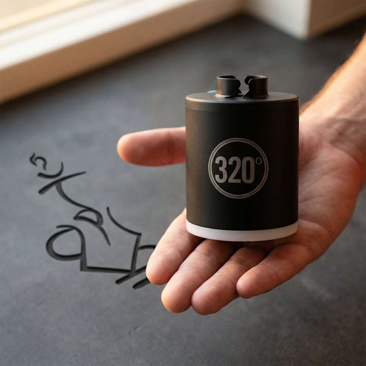 320° LED electric coal starter pump held in an open hand showing its compact palm-sized form factor — a portable hookah starter you can take anywhere., image 5 of 12