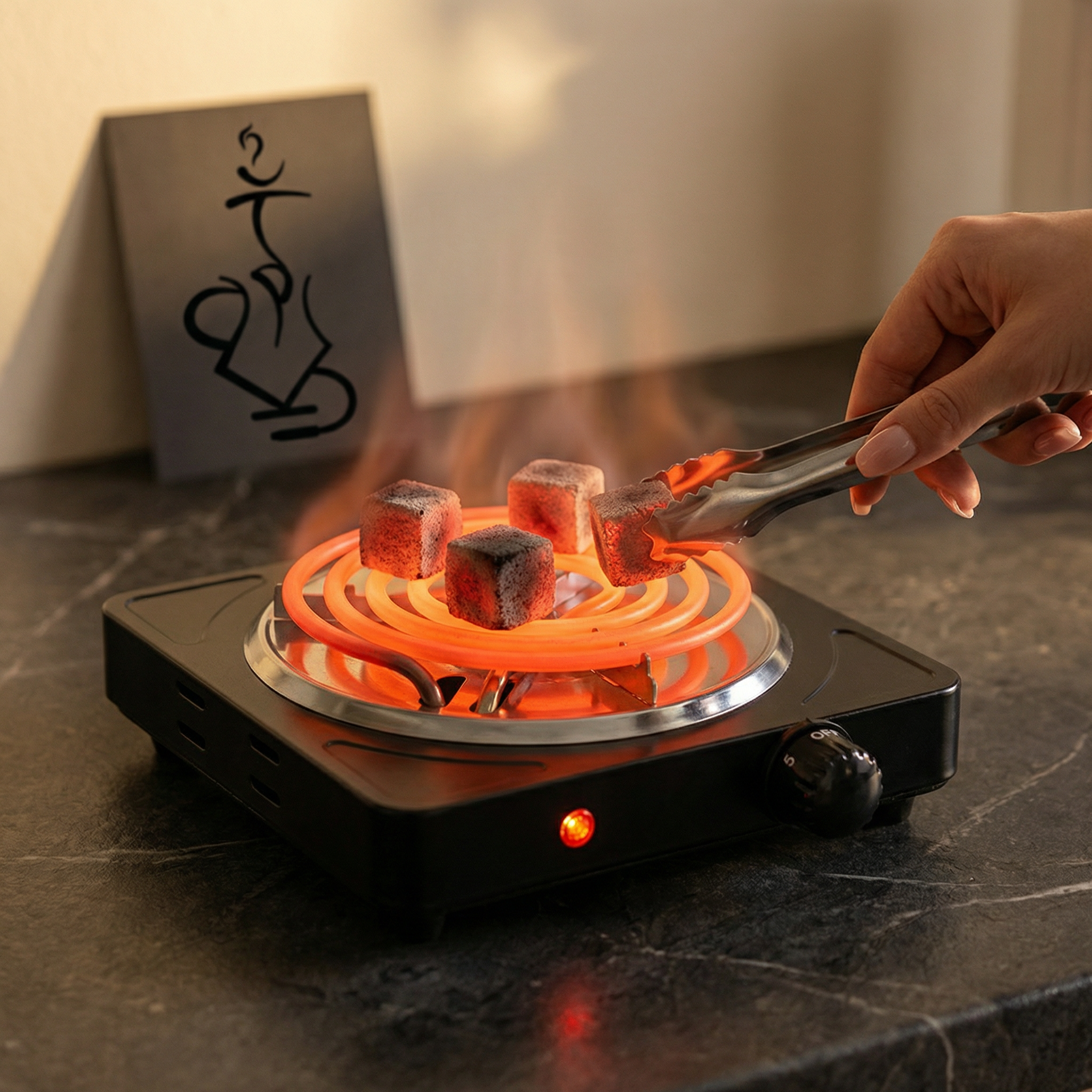 Hot plate with glowing orange coils and marshmallows being roasted on a dark surface.