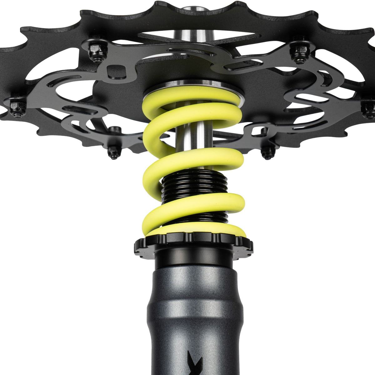 Amotion Pedal RX Slate chainring underside close-up — slate-grey bike-style cog over the yellow coil spring and stem, image 5 of 6