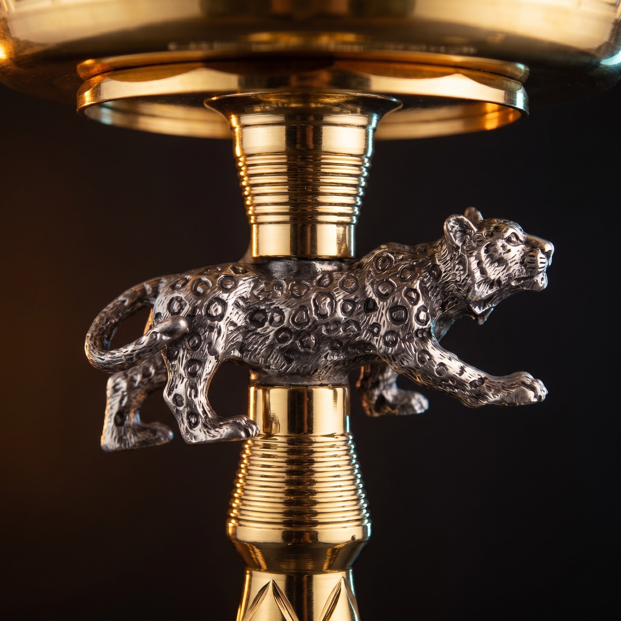 Silver-tone prowling jaguar figurine with oxidised rosette texture mounted on gold Basha Buzz stem