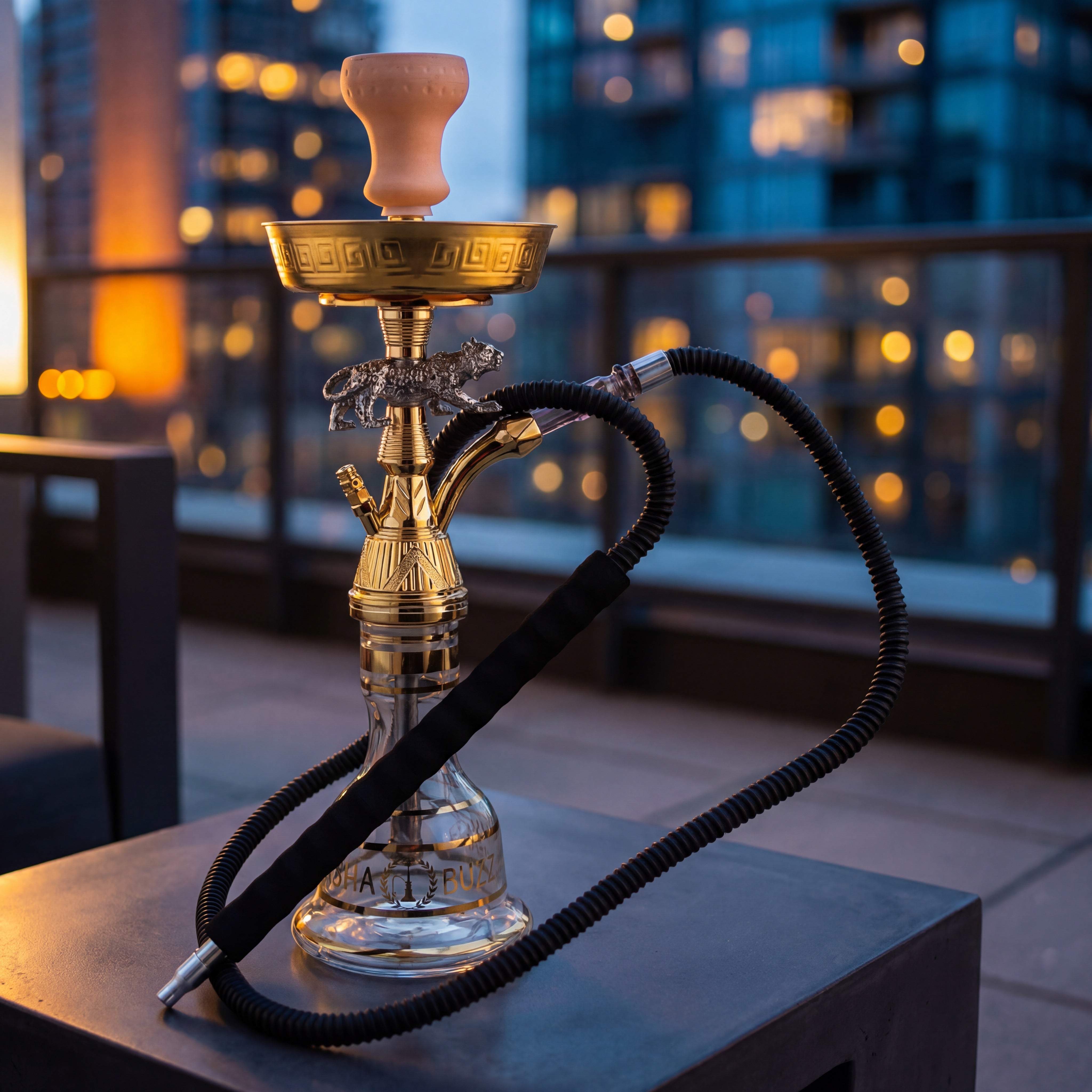 Basha Buzz Jaguar 44cm shisha pipe on concrete table with twilight city bokeh, gold and silver detail
