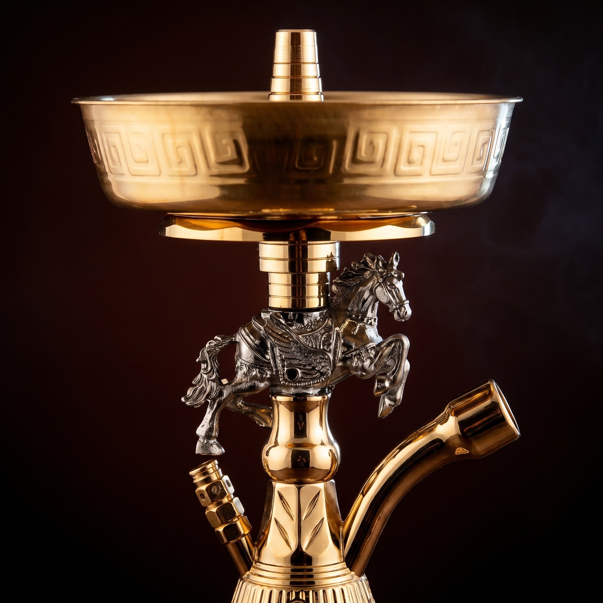 Close-up of the Basha Buzz Mustang silver rearing stallion with Greek key border on the gold ash tray above