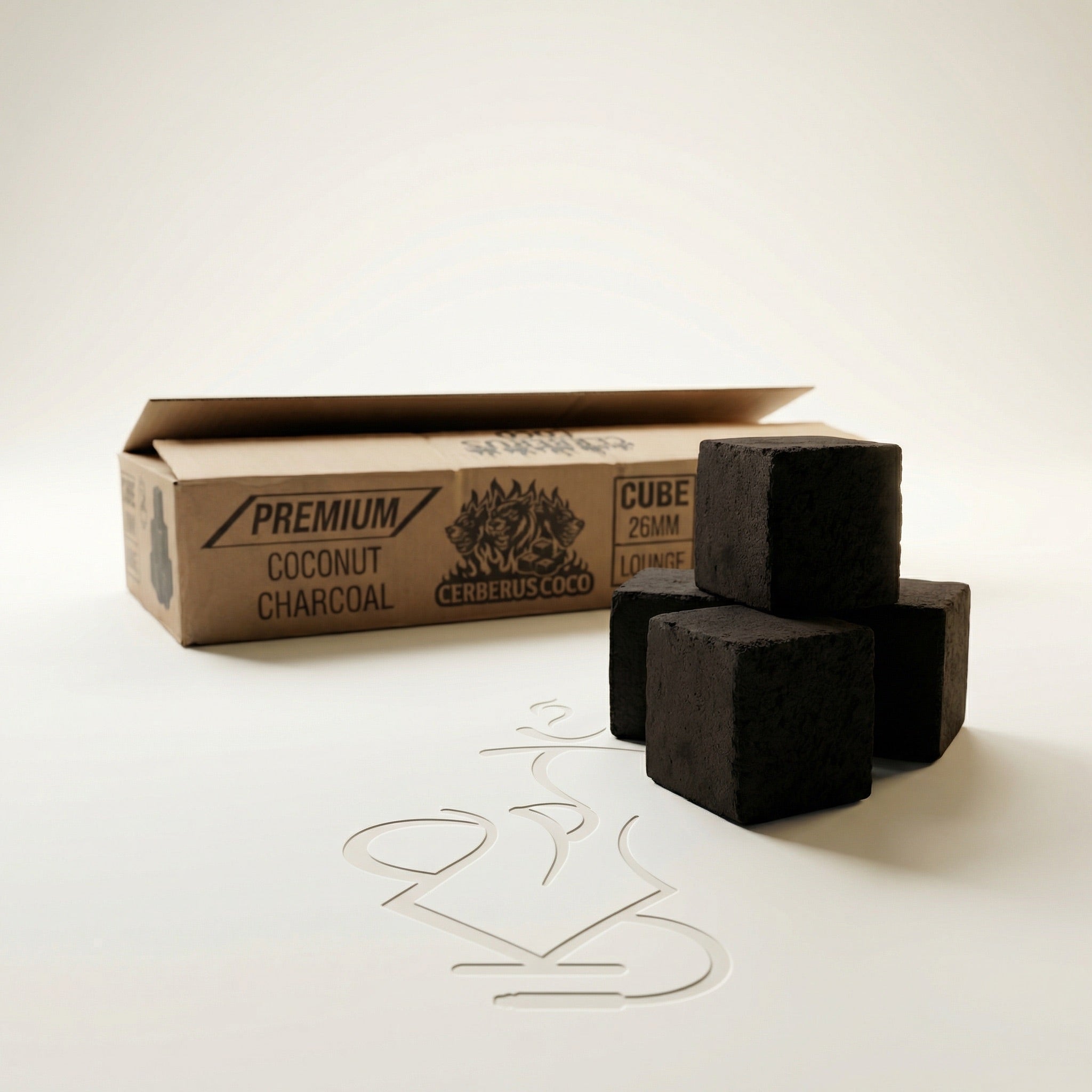 Cerberus Coco 26mm cube coconut shisha charcoal 10kg lounge box with loose cubes arranged in front showing dense compressed coconut shell texture.