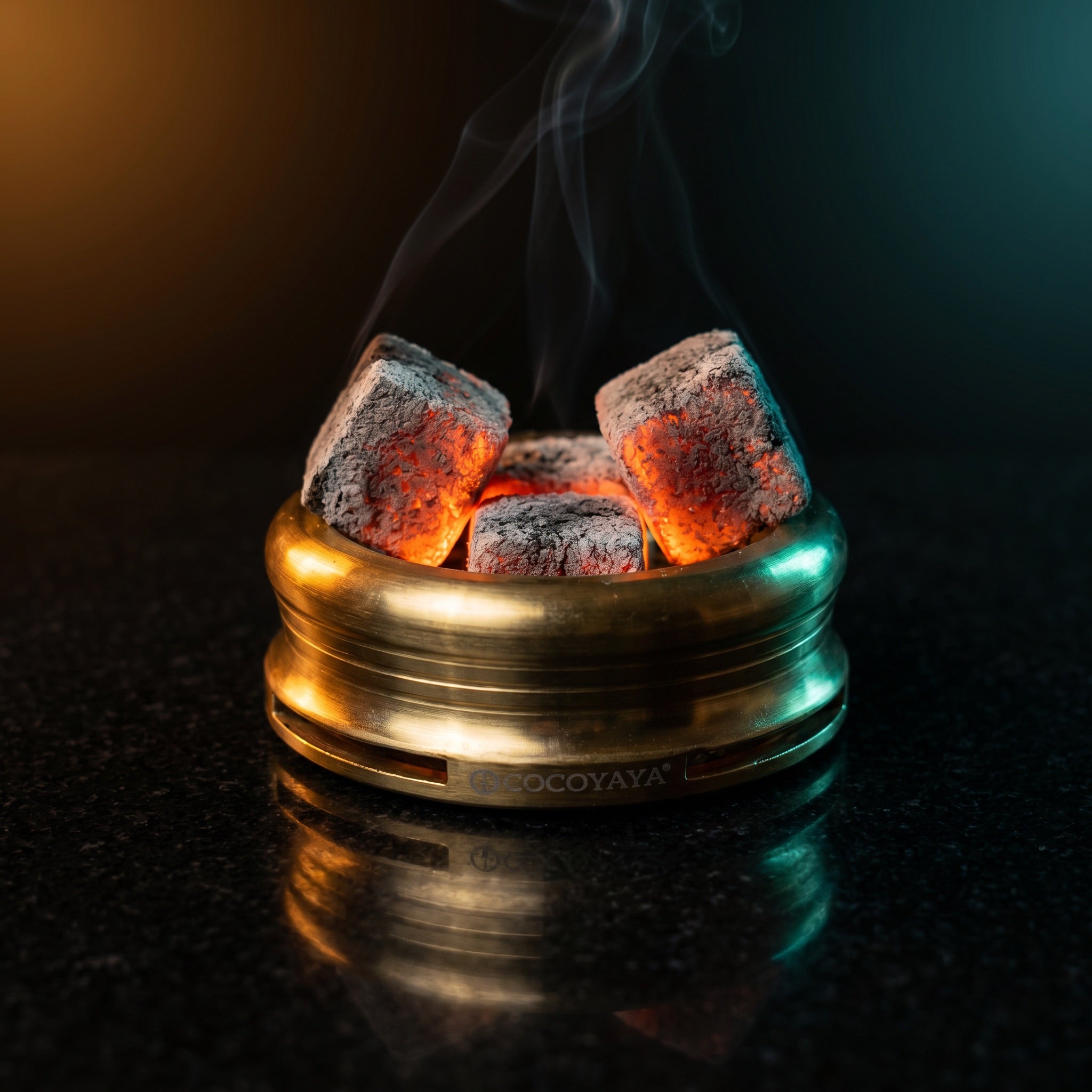 Cocoyaya Pro 5 HMD with lit coconut coals, brushed gold body on polished black stone, premium lounge atmosphere