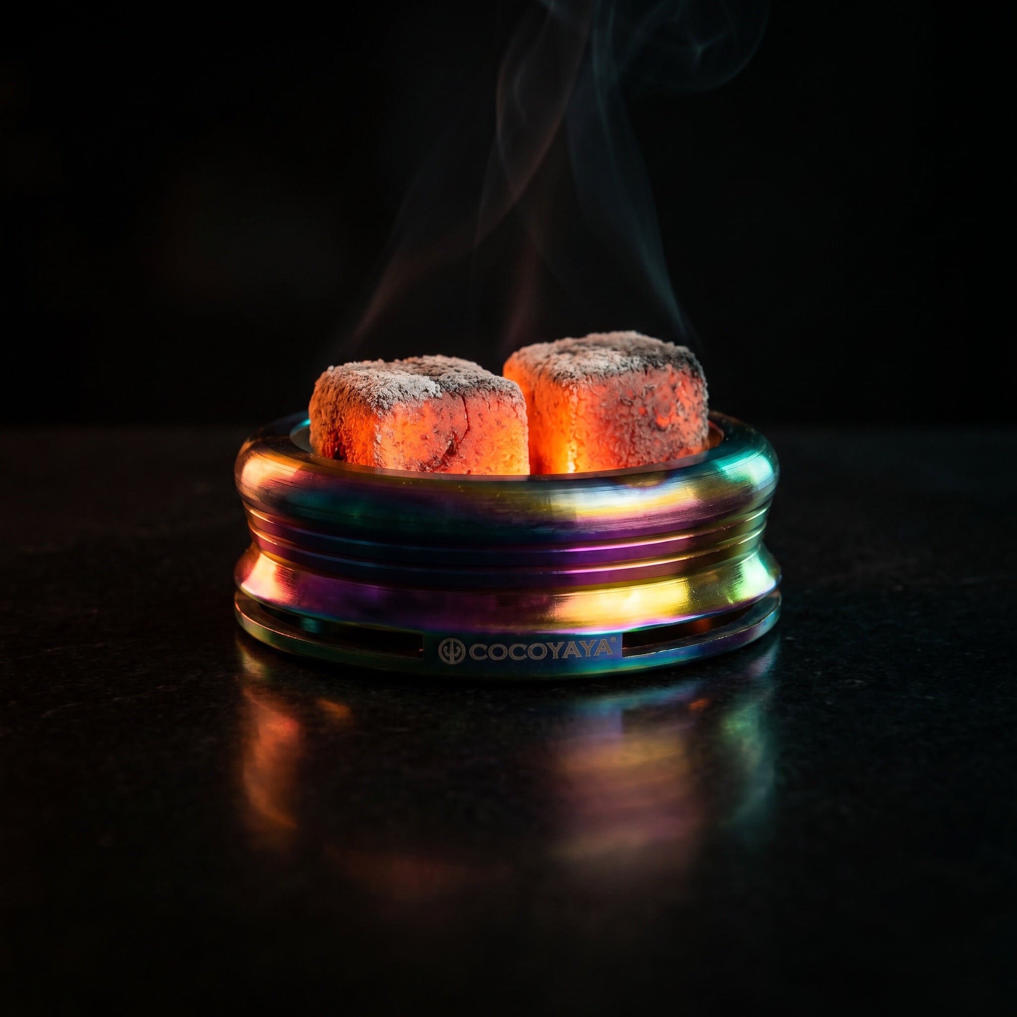 Cocoyaya Pro 5 Rainbow HMD with two lit coals on polished black surface, smoke ribbon, The Premium Way