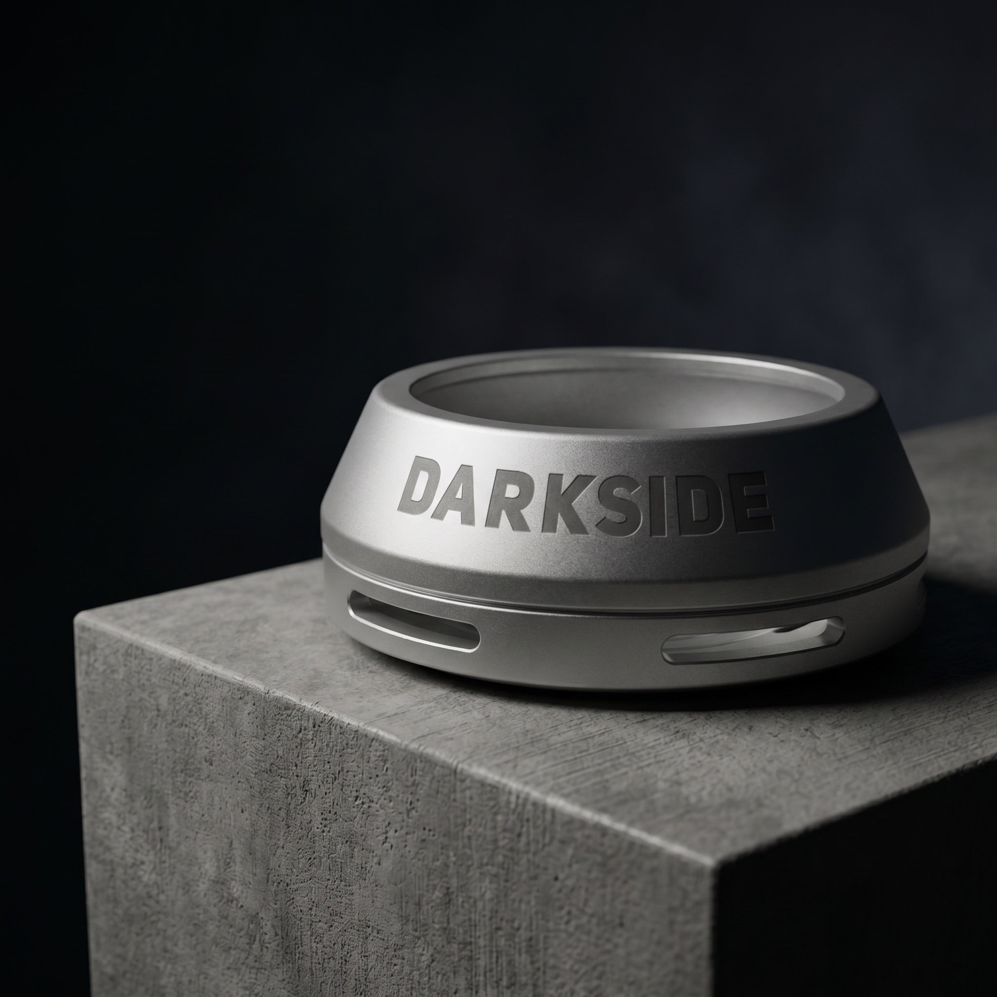 Darkside D-Heater Silver HMD on brushed concrete plinth in modern enthusiast workspace