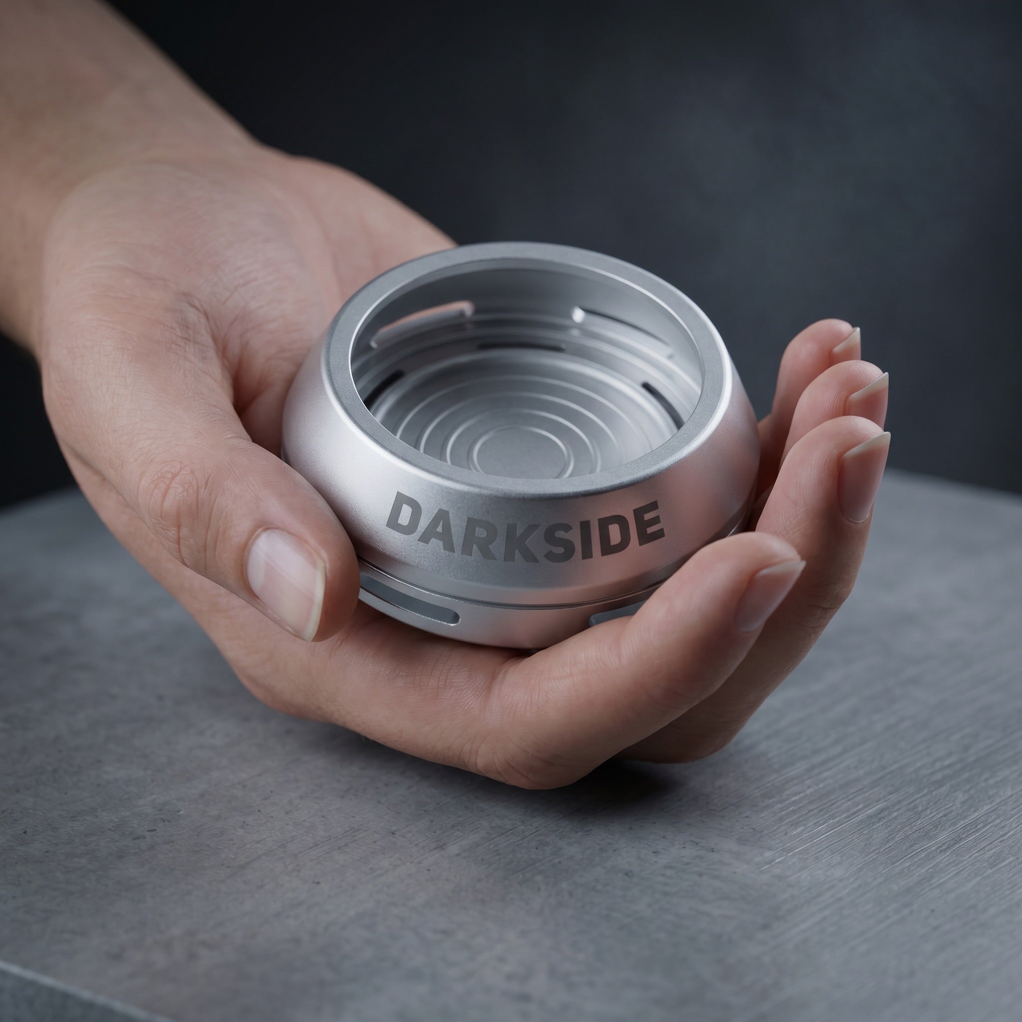 Darkside D-Heater Silver palm-sized HMD cradled in an open hand showing compact size