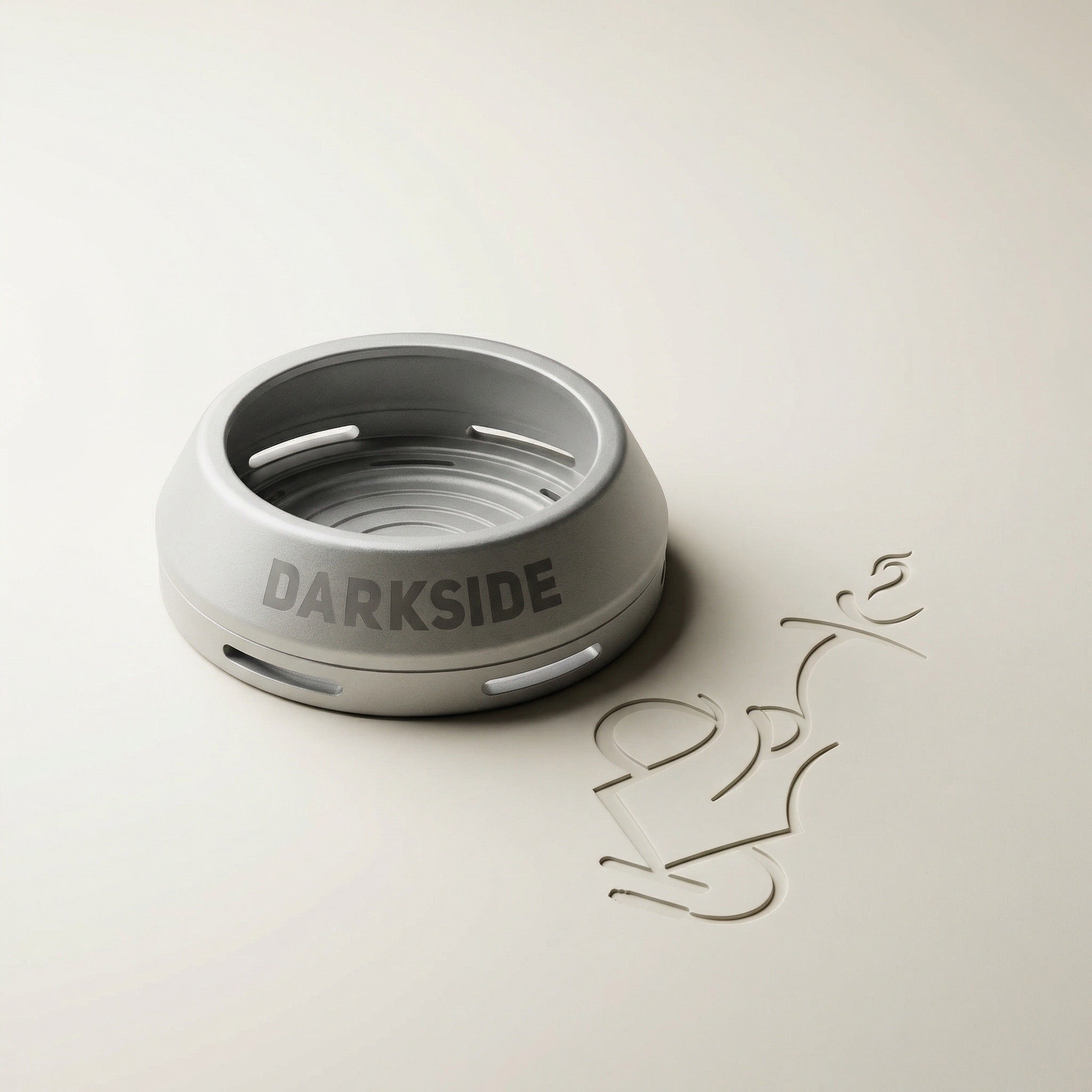 Darkside D-Heater Silver lidless anodised aluminium HMD photographed on a warm white studio sweep, showing the tapered outer profile and debossed DARKSIDE wordmark.