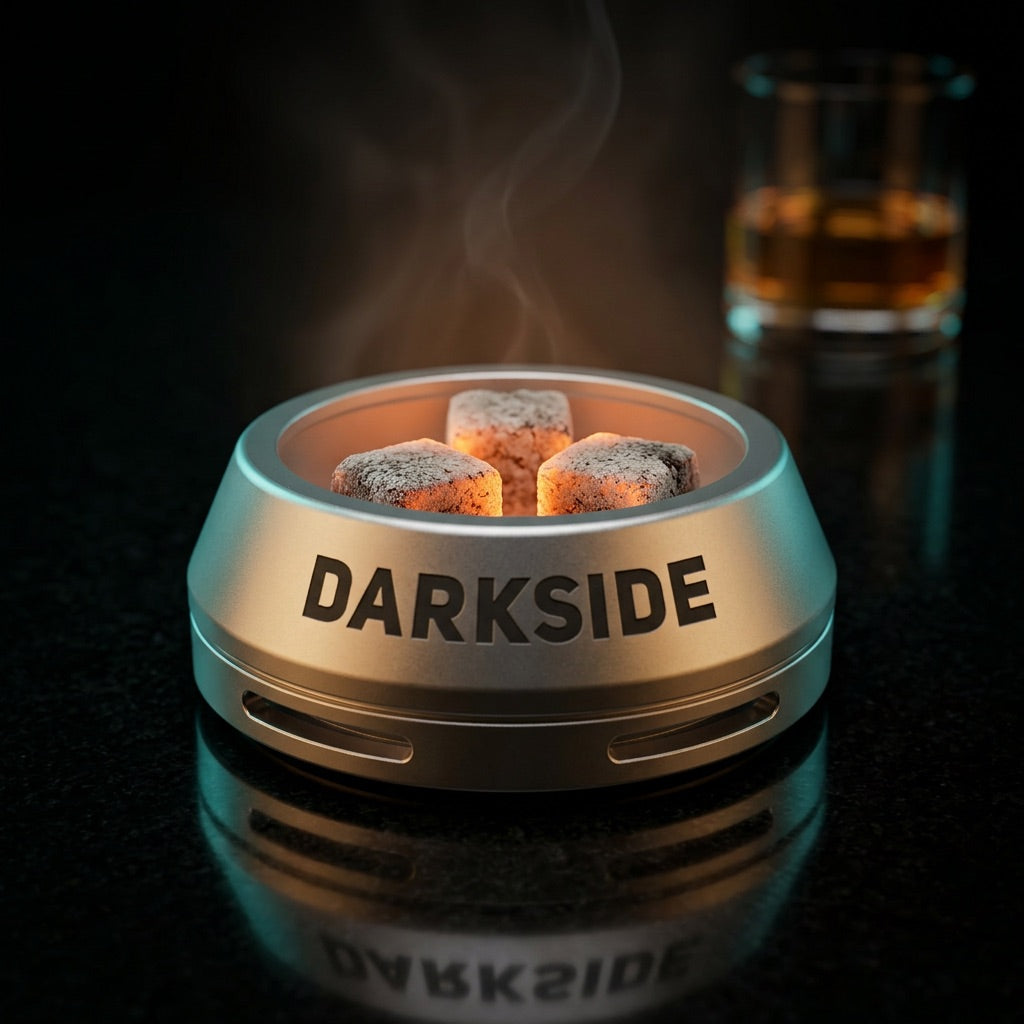 Darkside D-Heater Silver HMD with three lit coconut coals on polished black stone in premium lounge