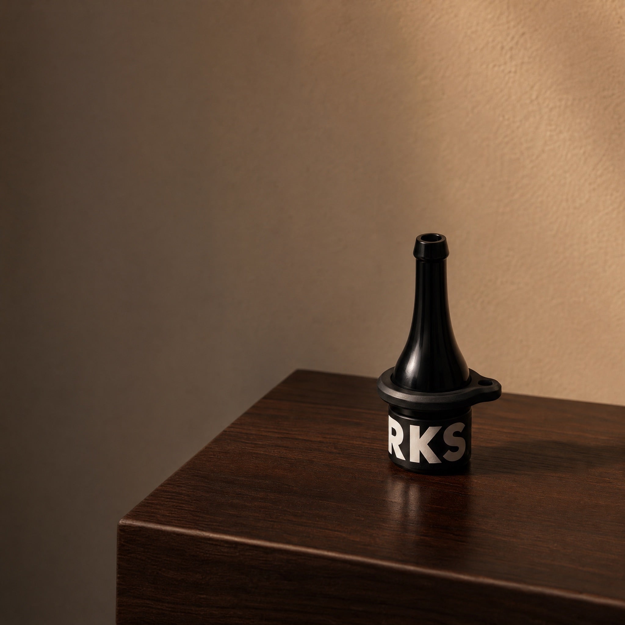 Darkside D-Stick Base mouthpiece on dark walnut console at twilight, warm directional light, lifestyle hero