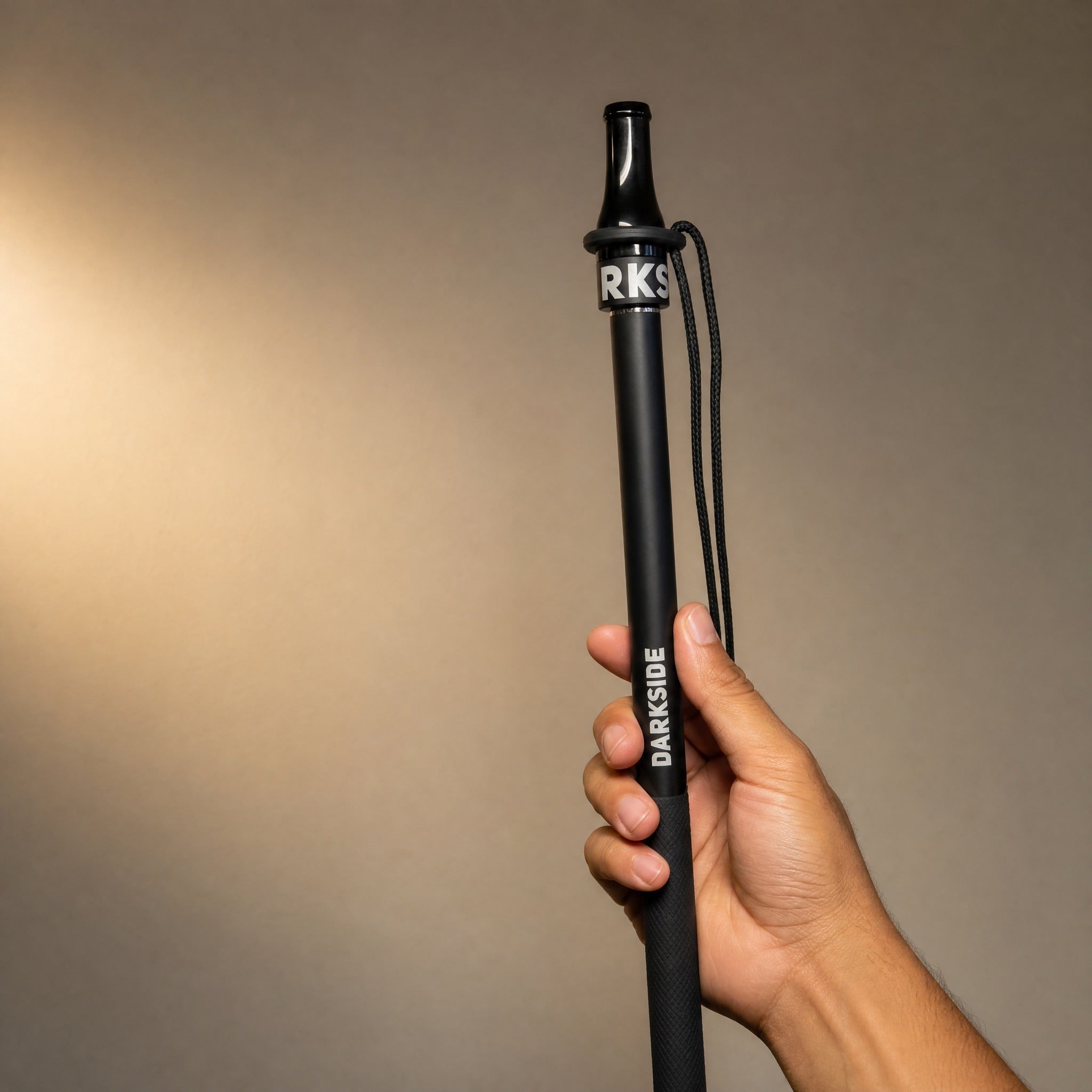 Darkside D-Stick Base mouthpiece fitted on Darkside hose handle showing universal fit, held in hand