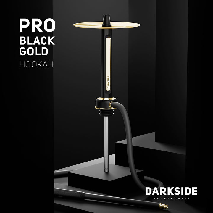 Darkside Pro Black Gold shisha on a dark podium with its hose coiled at the base