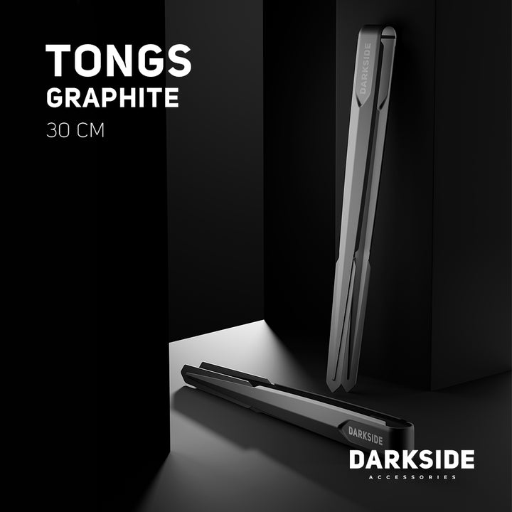 Darkside 30cm Graphite tongs shown upright and lying flat on a dark studio surface