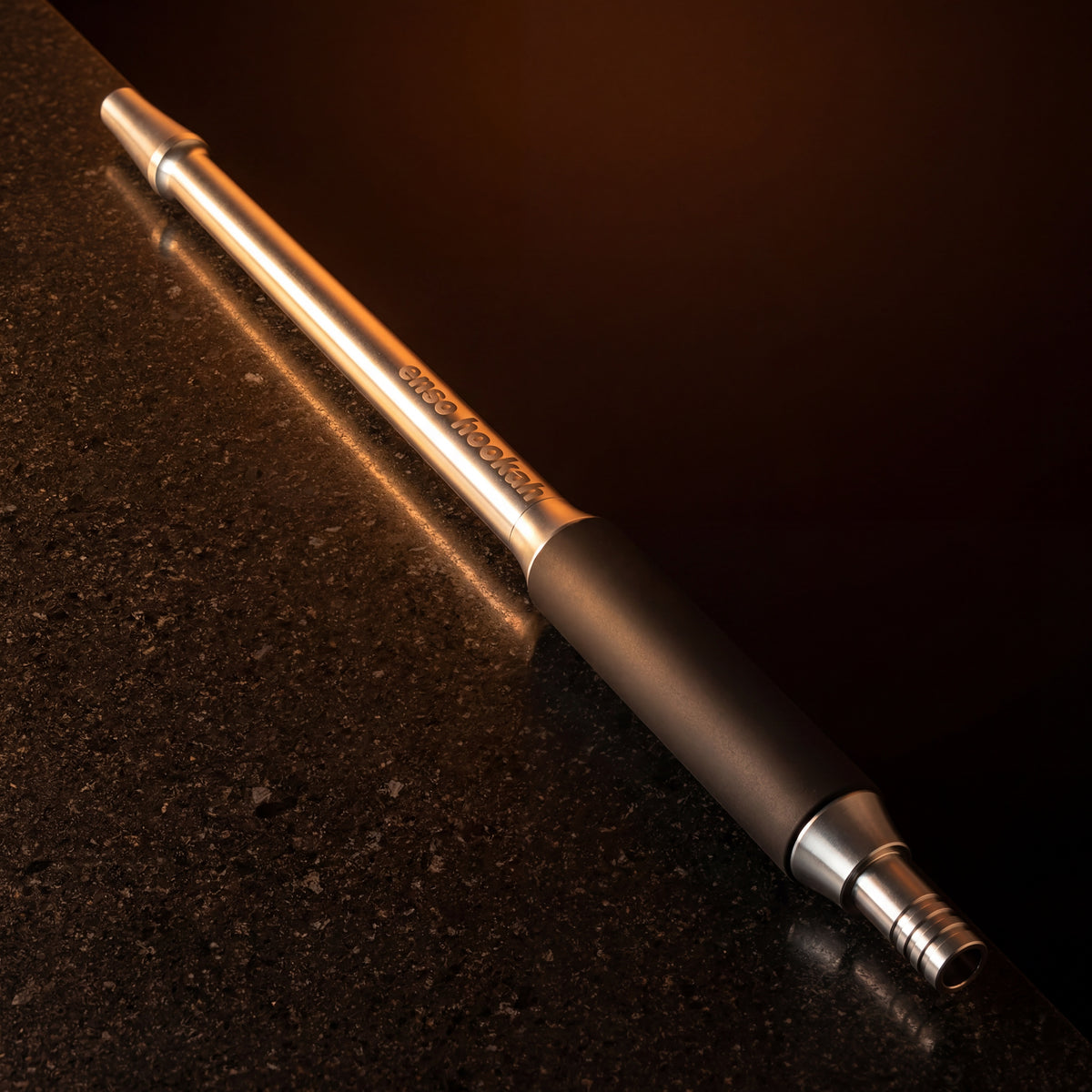 Enso Hookah Modular Mouthpiece lit by warm amber glow on a dark stone surface – The Premium Way, image 3 of 12