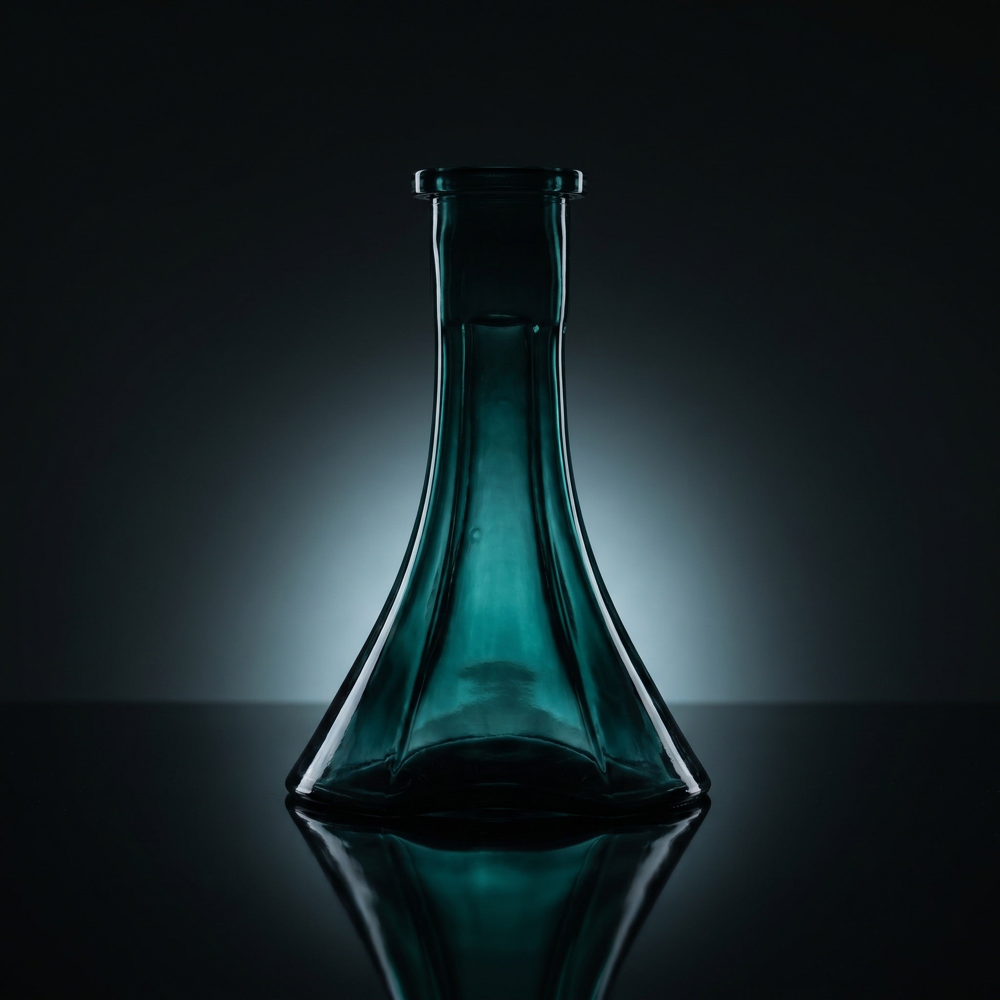 Forest Trefoil shisha vase silhouetted on dark mirror, deep green glass glowing from within, sculptural three-lobe form