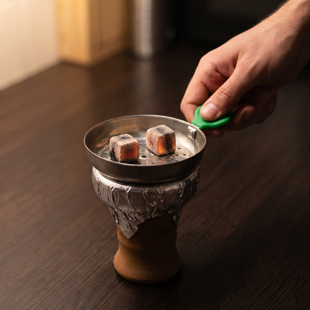 Essentials Leaf Heat Management Screen in use on a shisha bowl with lit natural charcoal cubes from The Premium Way, image 2 of 6