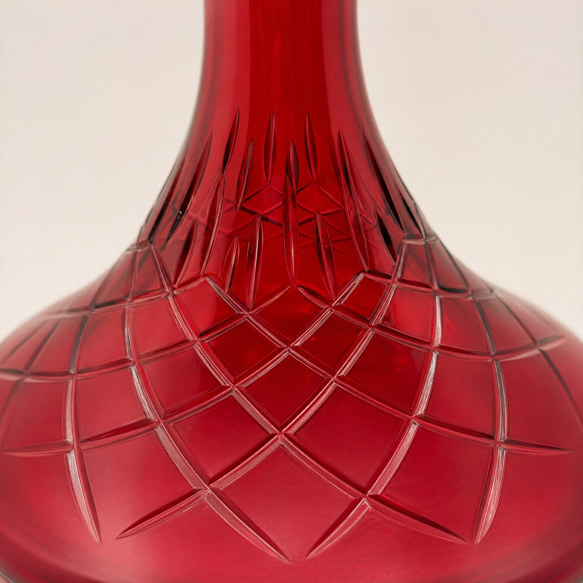 Macro detail of Essentials Ruby Star-Cut shisha vase showing leaf-band collar and radiating star-cut belly motif in ruby glass, image 3 of 3