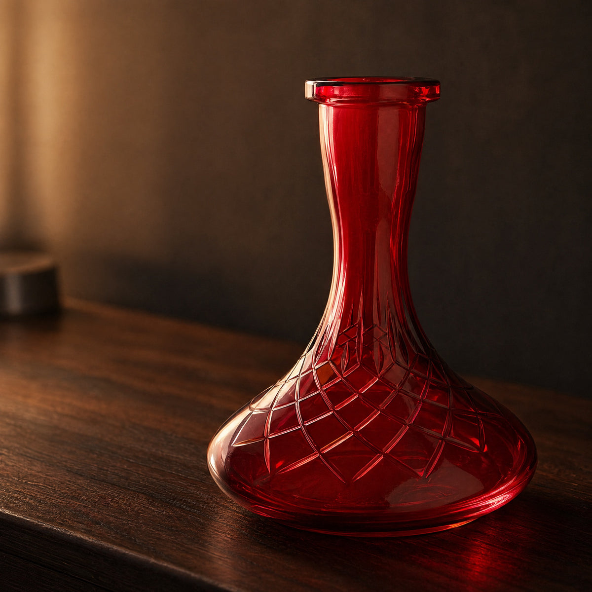 Essentials Ruby Star-Cut shisha vase glowing on a dark walnut sideboard at dusk, ruby tint backlit through cut belly, image 2 of 3