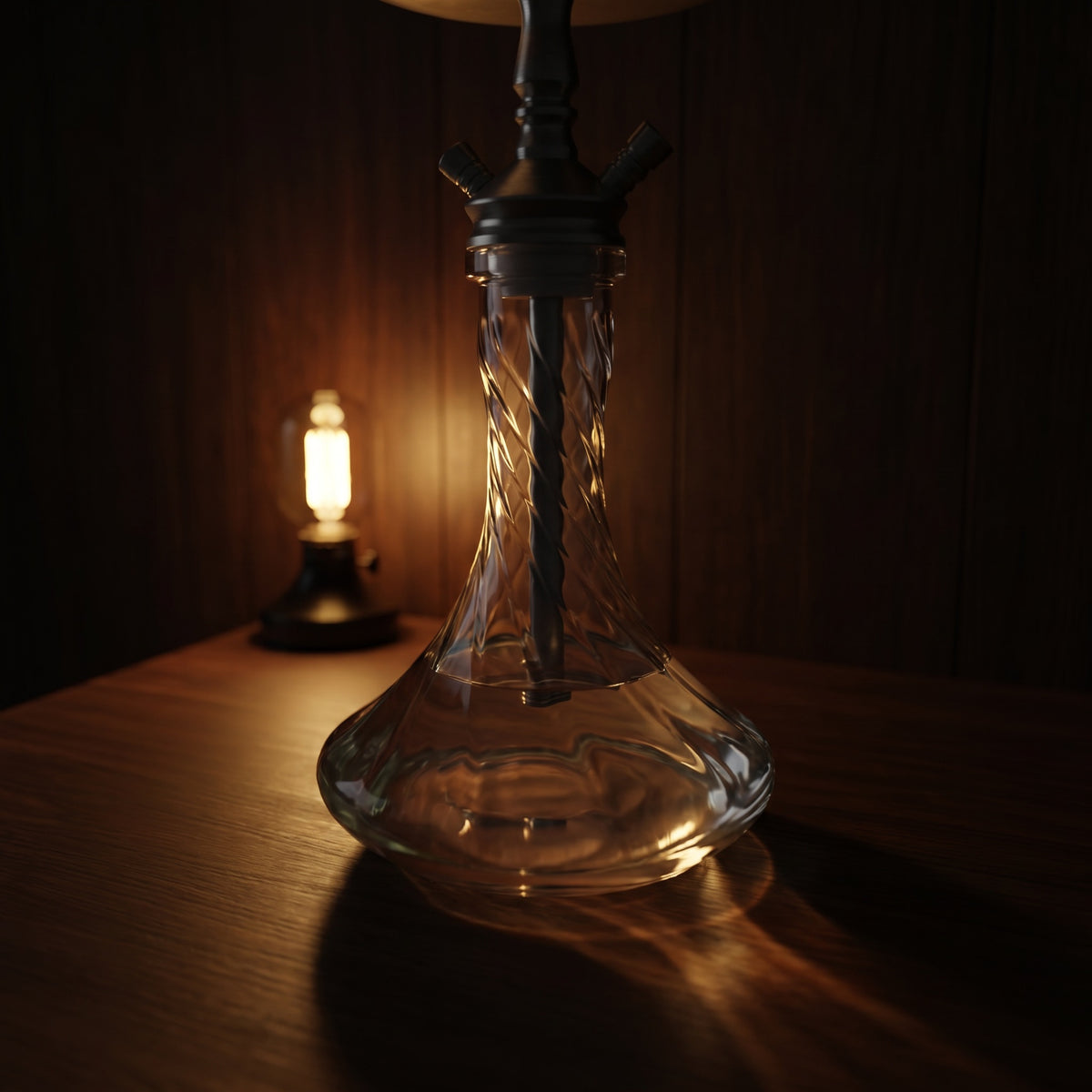 Essentials Twist Clear shisha vase mounted on a hookah at low light, moulded spiral catching warm lamp glow across dark wood, image 2 of 5
