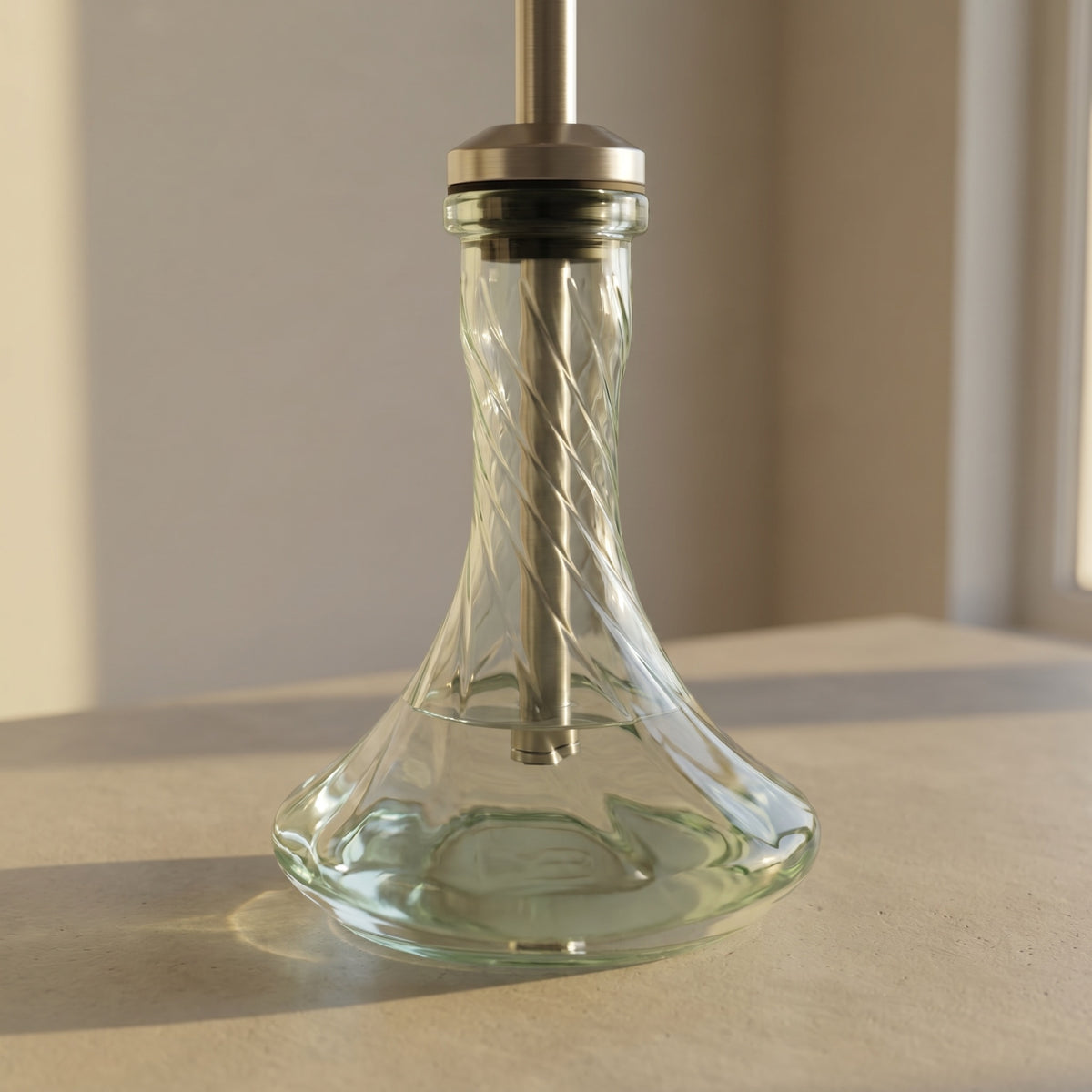 Essentials Twist Clear shisha vase paired on a brushed steel stem in golden hour daylight, spiral magnified through the glass body, image 3 of 5