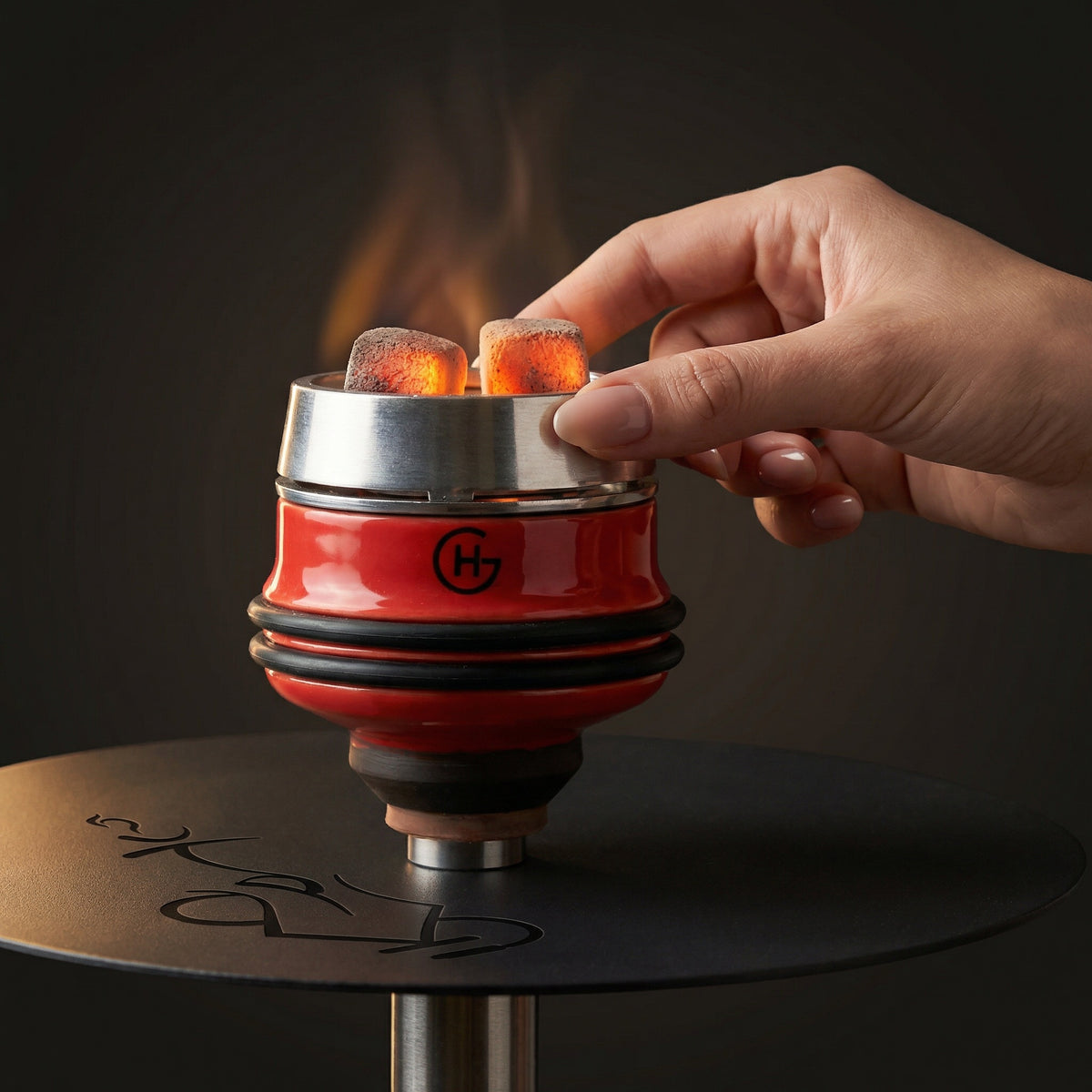 Geometry Short Phunnel Bowl in red mounted on a hookah with heat management device and glowing coals, hand adjusting the HMD mid-session., image 2 of 8