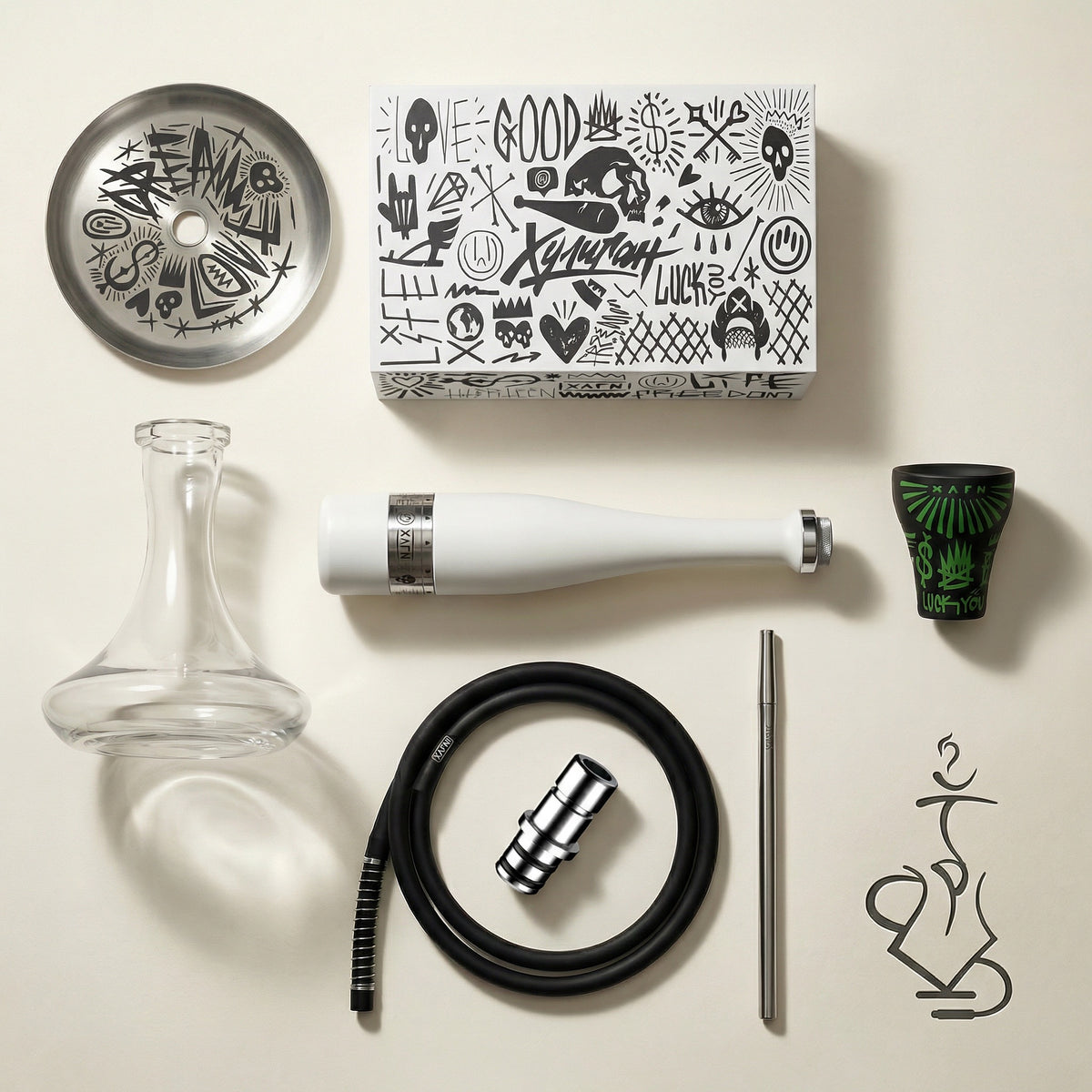 Hooligan White Baseball Bat Hookah complete set flat lay showing the stem, glass base, ash plate, graffiti bowl, silicone hose, chrome mouthpiece and adapter laid out on warm white studio paper., image 3 of 25