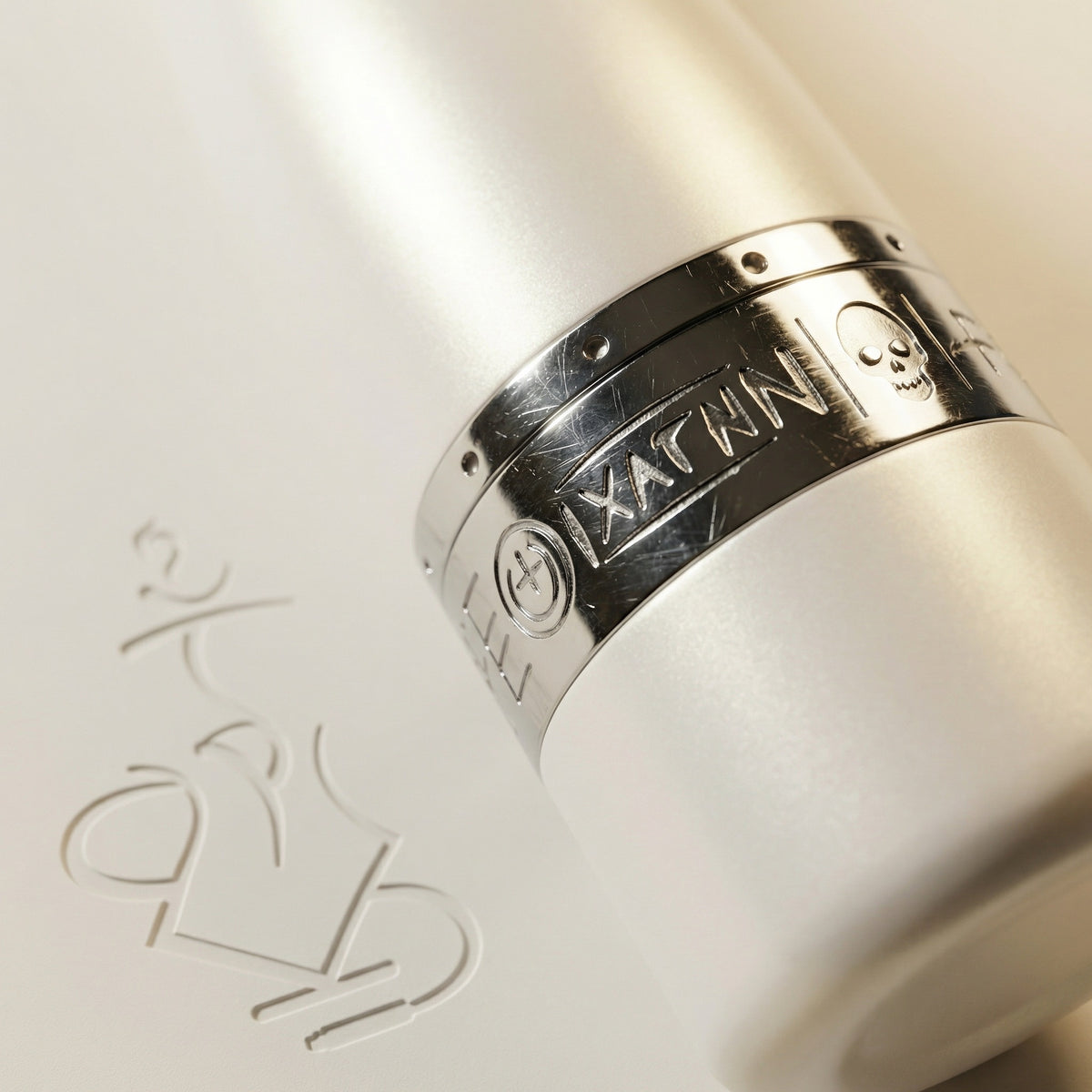 Macro detail of the engraved chrome purge collar on the Hooligan White Baseball Bat Hookah, showing the hand-engraved Hooligan graffiti band where the chrome meets the pearlescent white stem., image 5 of 25