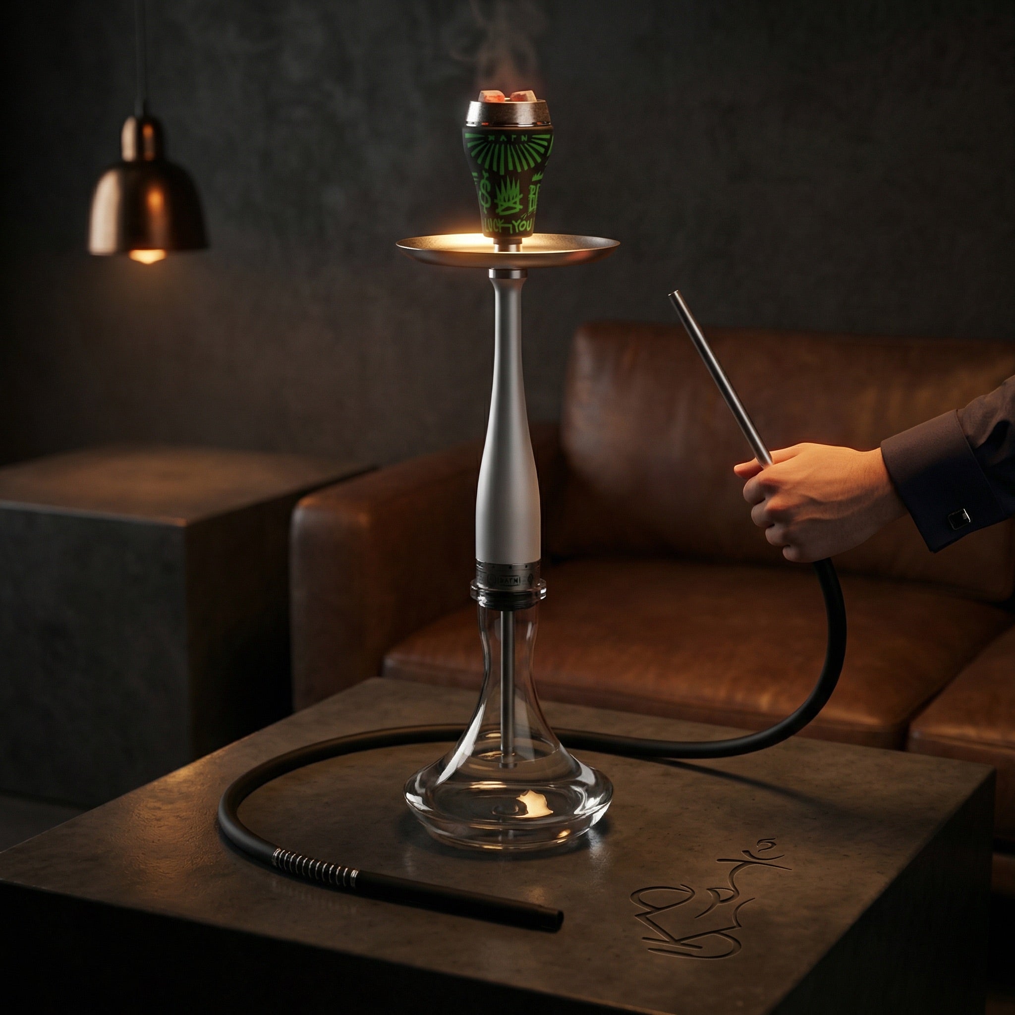 Hooligan White Baseball Bat Hookah set up in a moody premium lounge with a hand gripping the chrome hose handle, full session-ready assembly with bowl and hose connected.