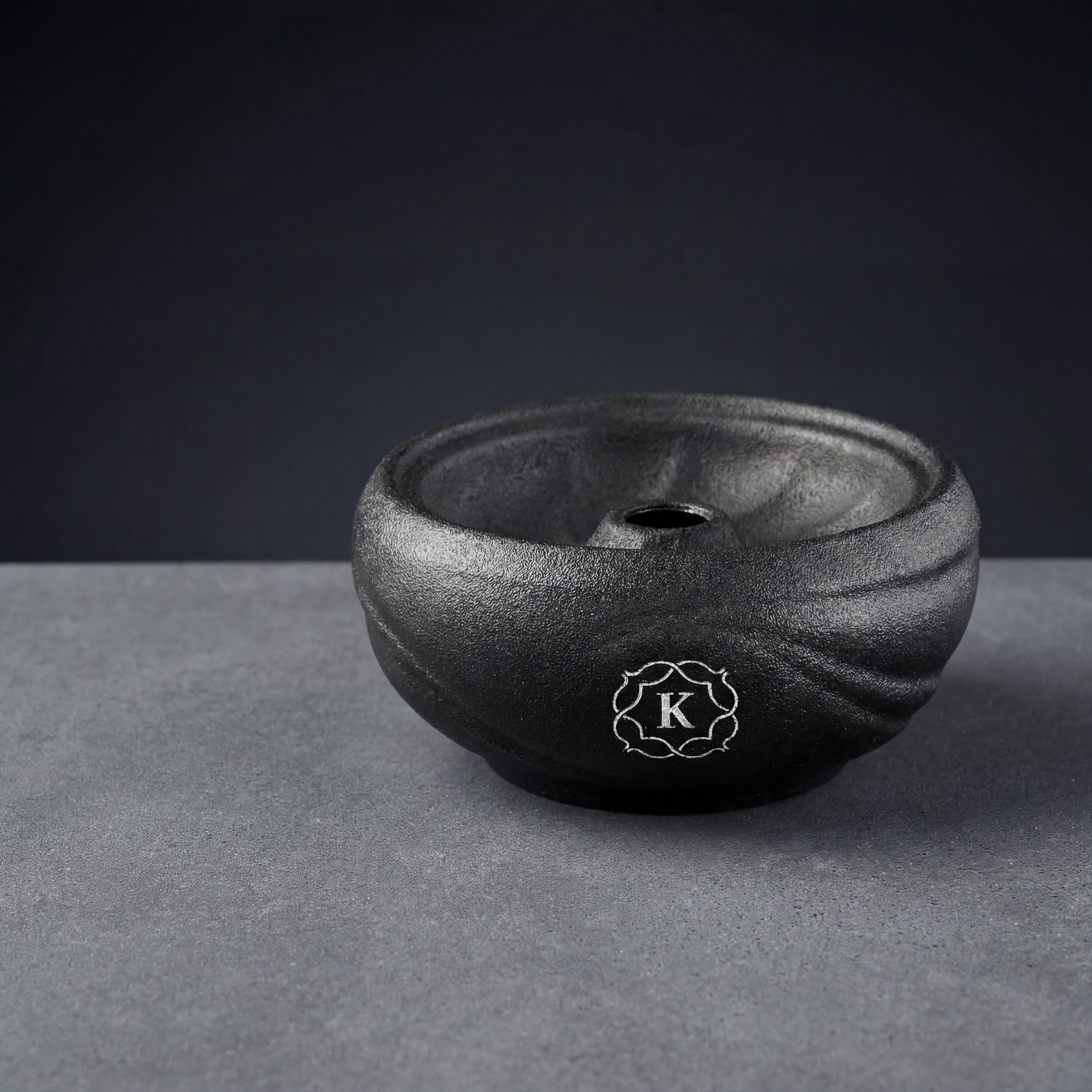 Kaloud Kore All Ceramic phunnel bowl on concrete slab with cool architectural lighting, silver cartouche