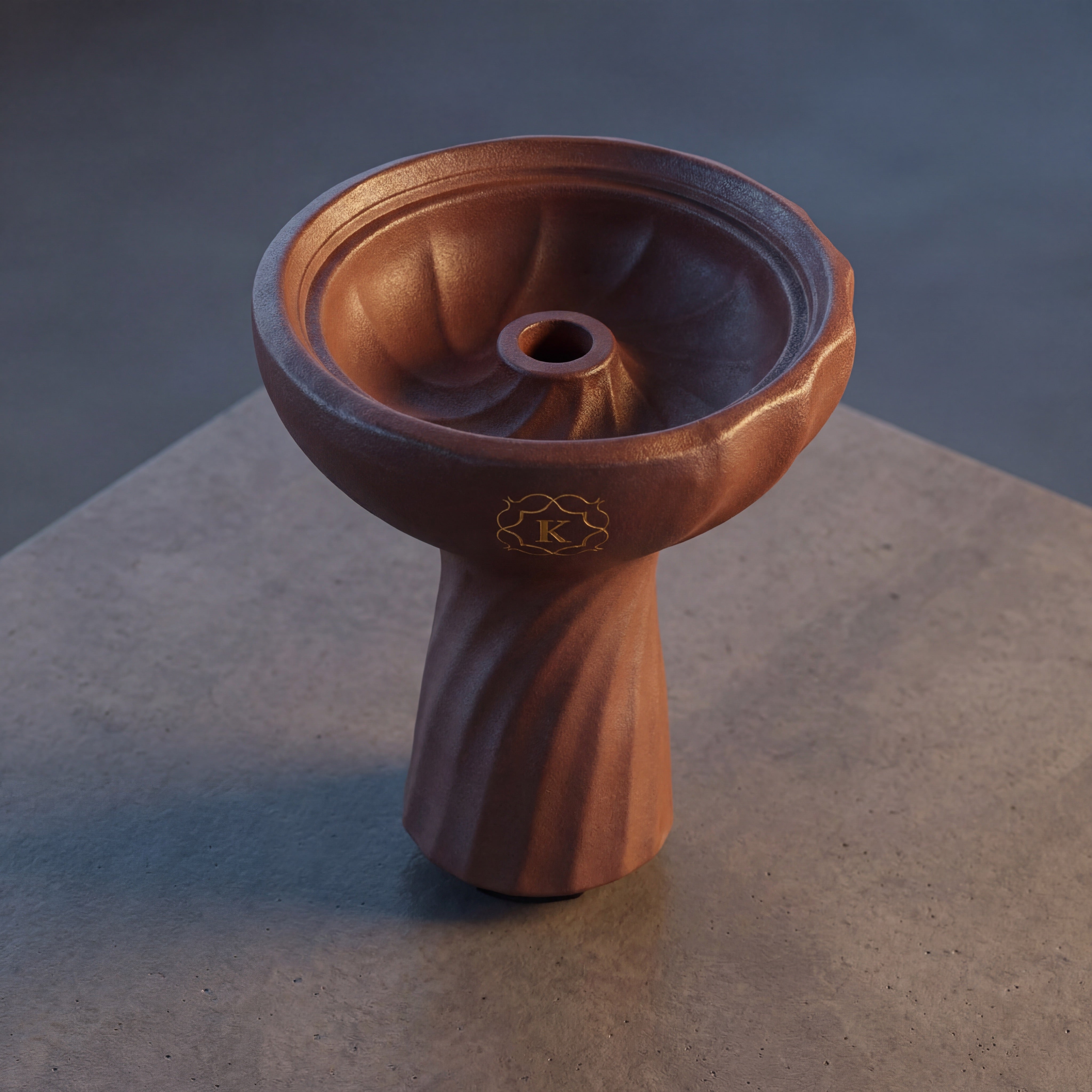 Kaloud Samsaris Kore Qì Tall red clay shisha bowl on polished concrete in dim modern interior with directional warm light