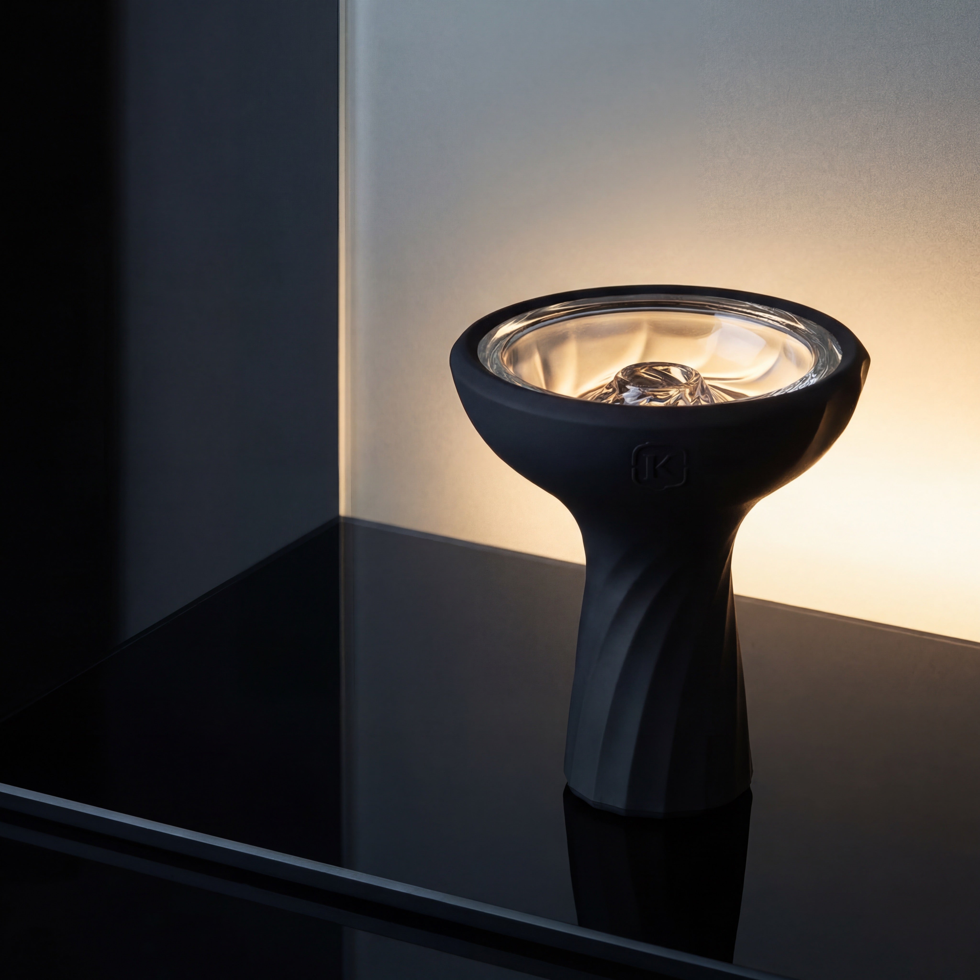 Kaloud Samsaris Vitria III borosilicate glass shisha bowl on polished black glass surface with frosted glass plane backlighting the clear basin