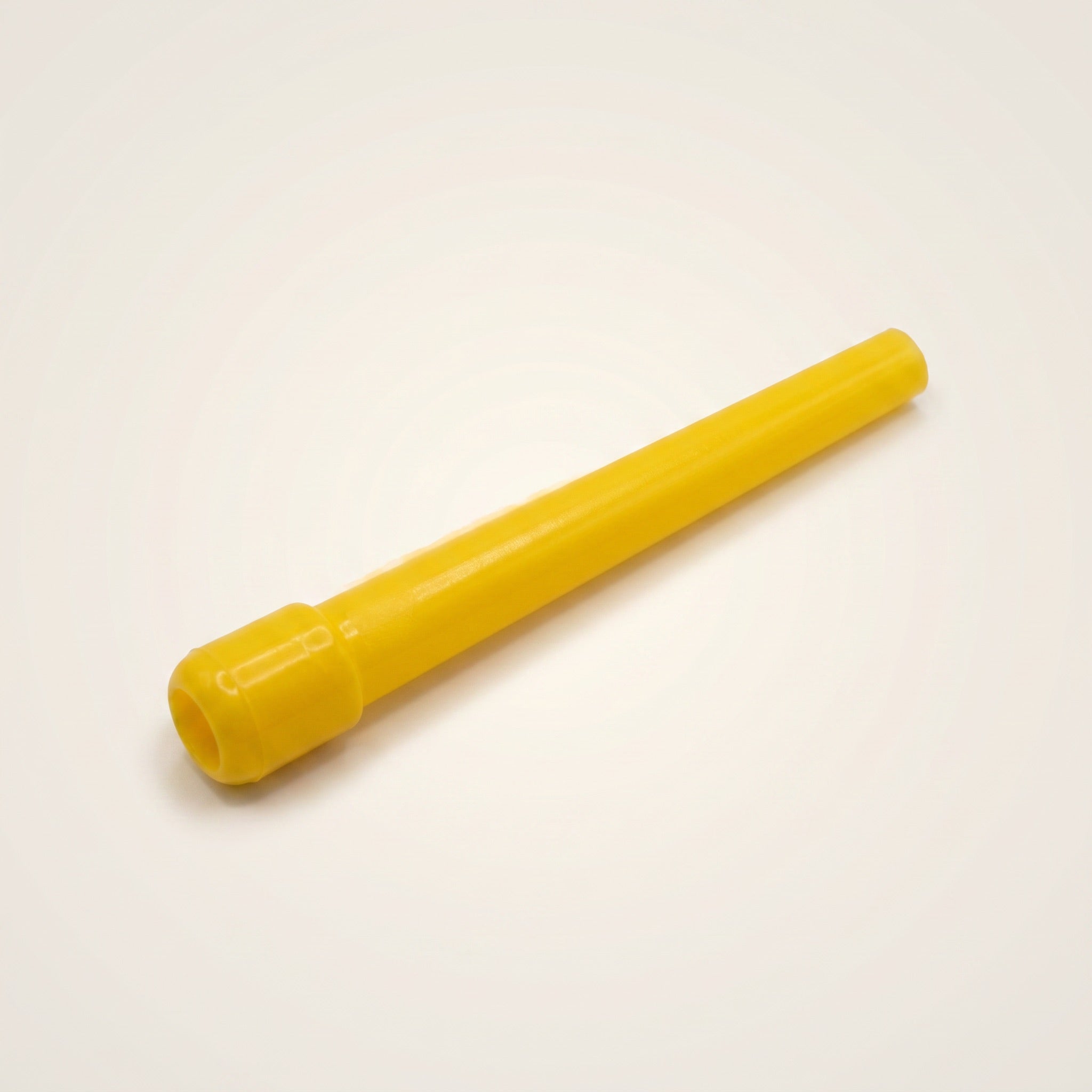 Close-up of a single Khalil Mamoon disposable shisha mouthpiece tip showing the flanged hose-end cap and tapered yellow plastic body