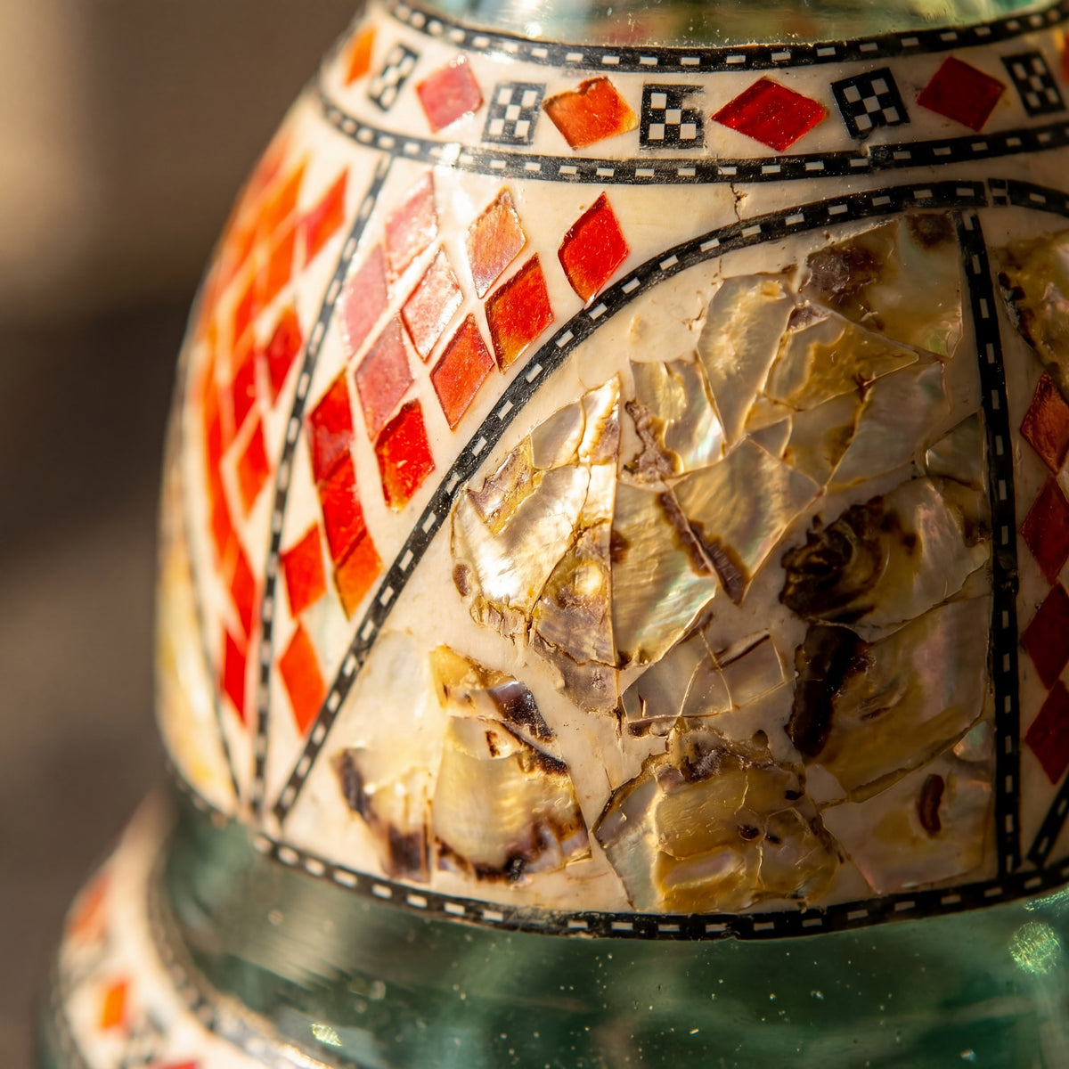 Macro of Khalil Mamoon Sadaf base showing hand-set red enamel diamonds and shell inlay, The Premium Way
, image 4 of 11