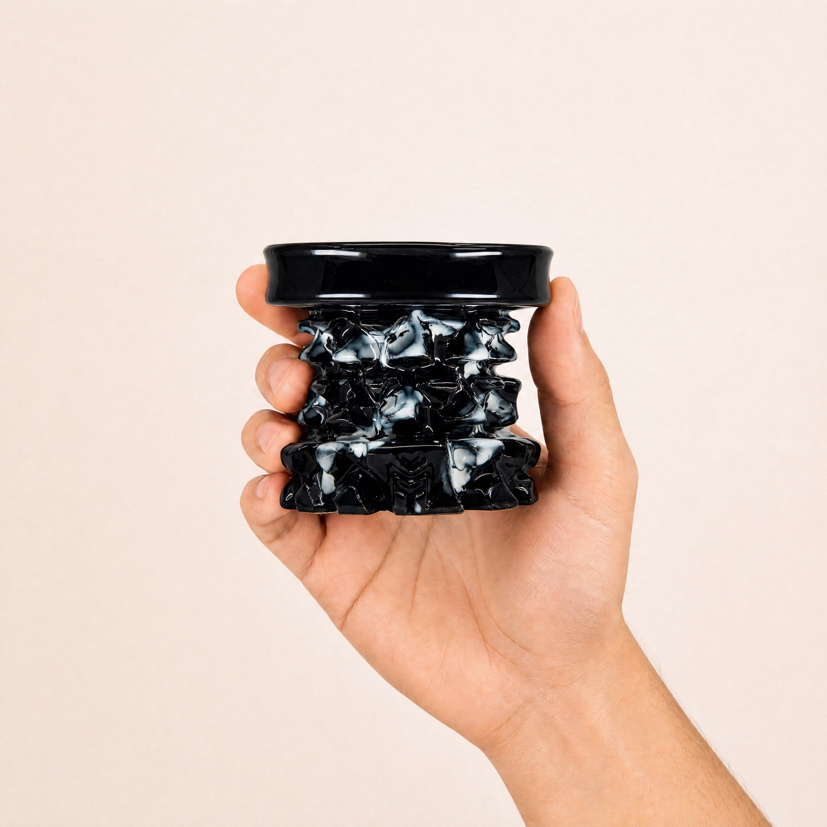 MIT Luxury Mitovation V2 Onyx bowl held in hand, showing 80mm scale and marbled black-and-cream relief