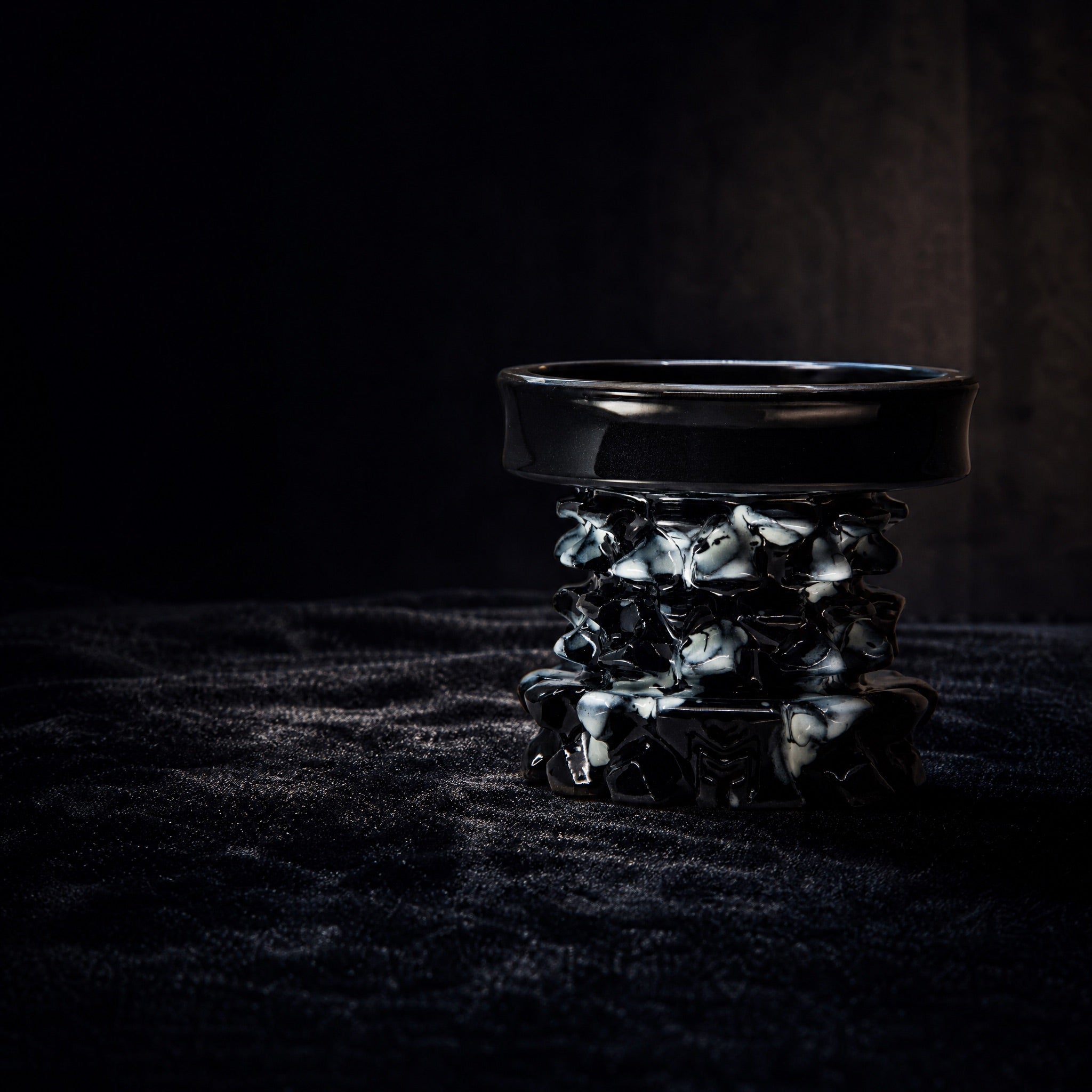 MIT Luxury Mitovation V2 Onyx bowl on black velvet vitrine, gallery specimen lit by single directional spotlight