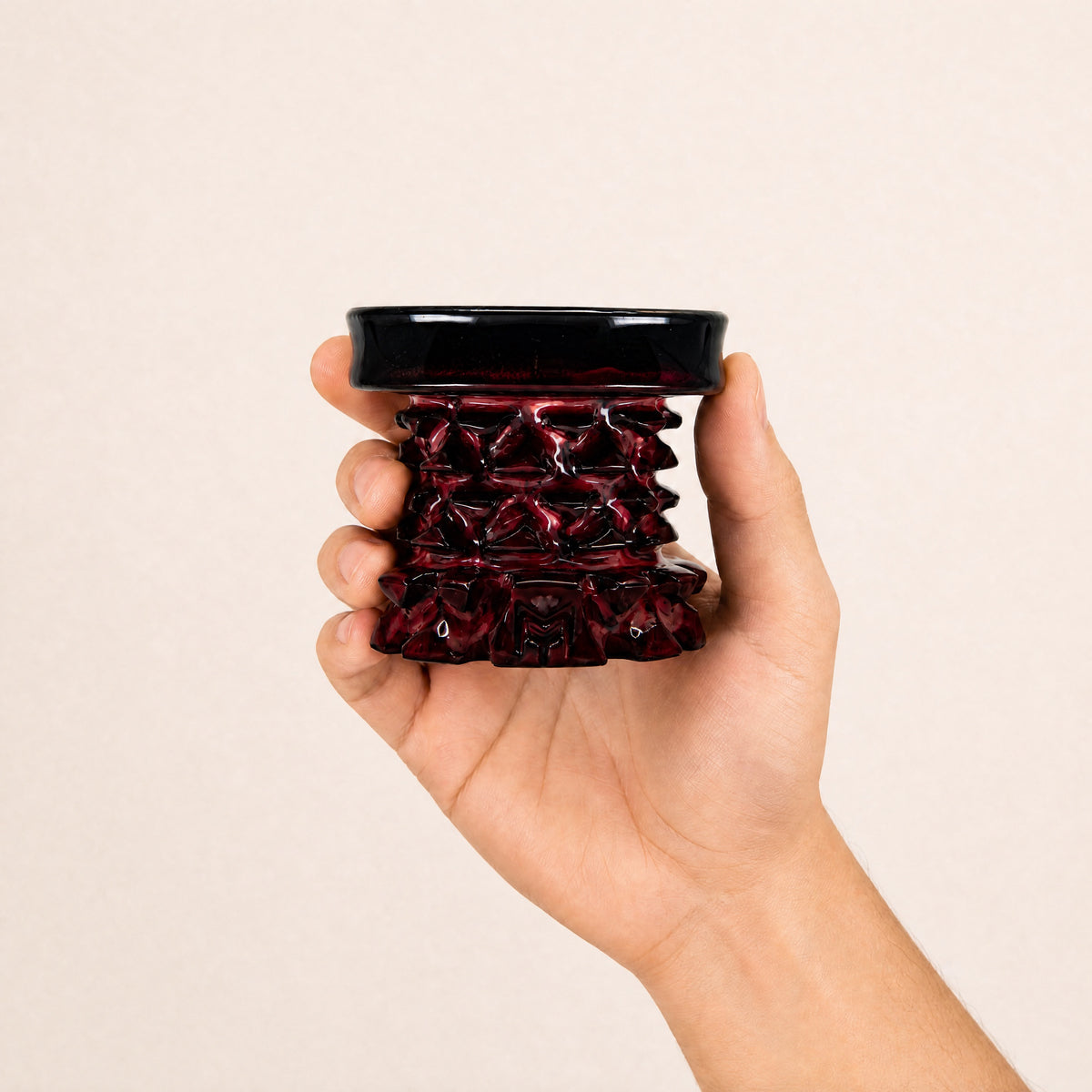 MIT Luxury Mitovation V2 Ruby bowl held in hand, showing 80mm scale and oxblood red glaze relief, image 5 of 6