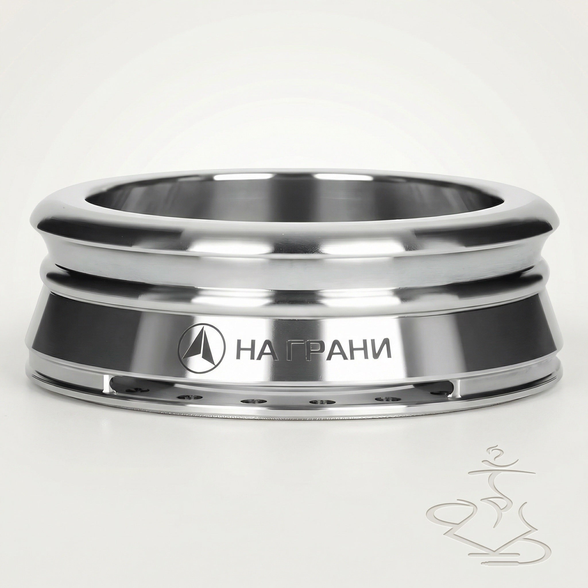 Na Grani On The Edge stainless steel heat management device with mirror-polished ridged bands and dark matte centre band, front three-quarter studio shot on warm white background