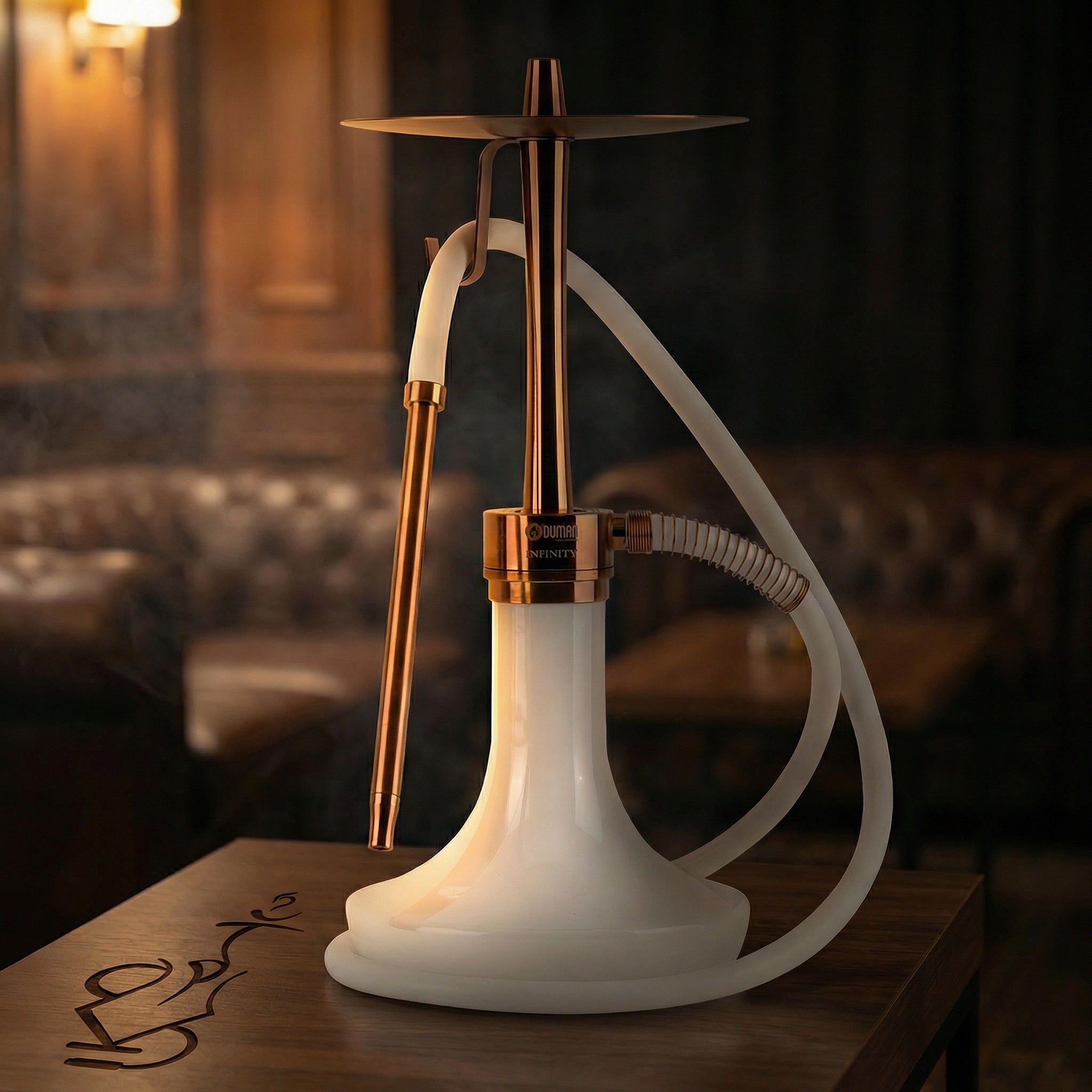 Oduman Infinity bronze and white glass shisha pipe set up on a walnut side table in a warm lounge, hand reaching for the mouthpiece mid-session.