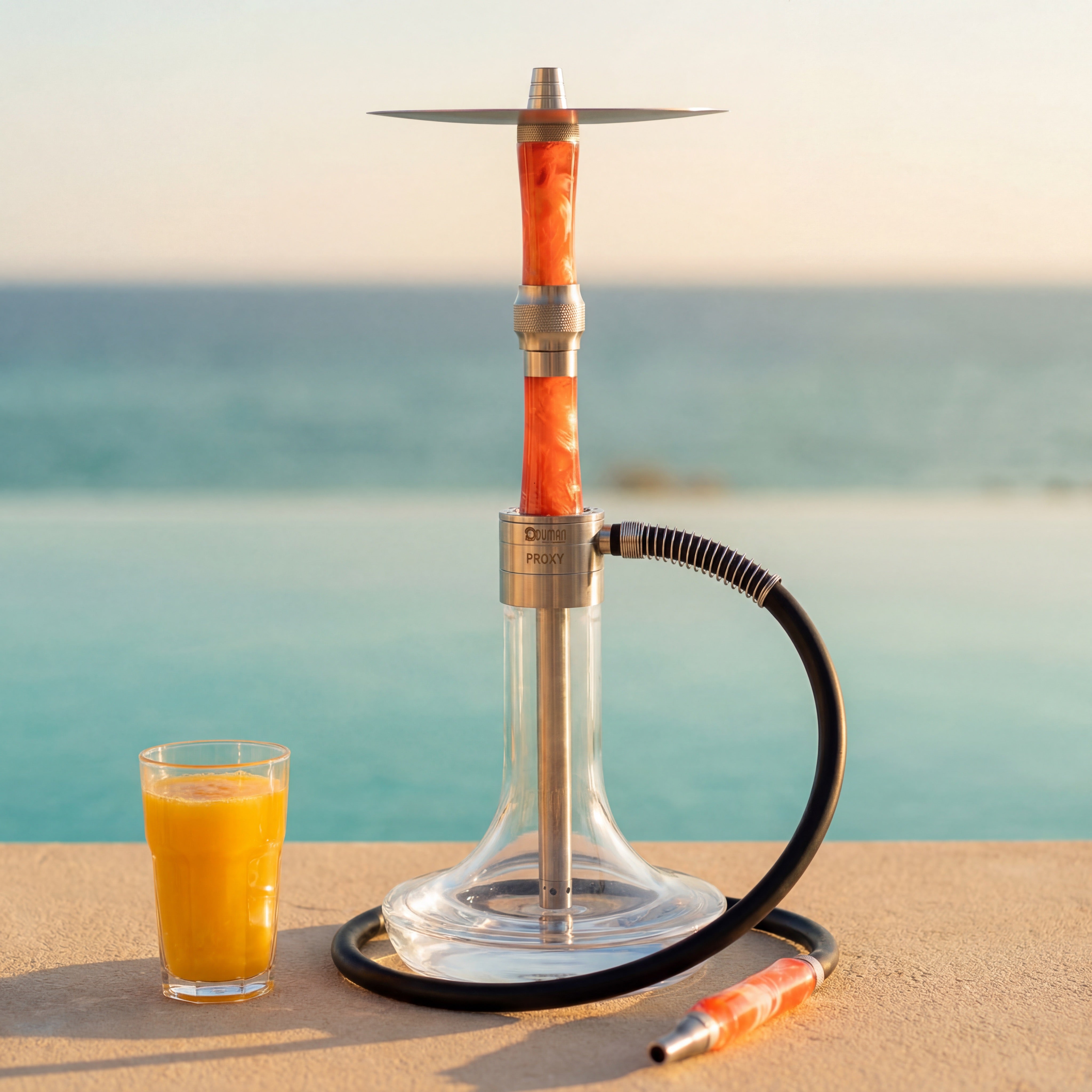 Oduman Proxy Ocean Orange shisha on a sandstone terrace at golden hour with the Mediterranean sea behind — The Premium Way