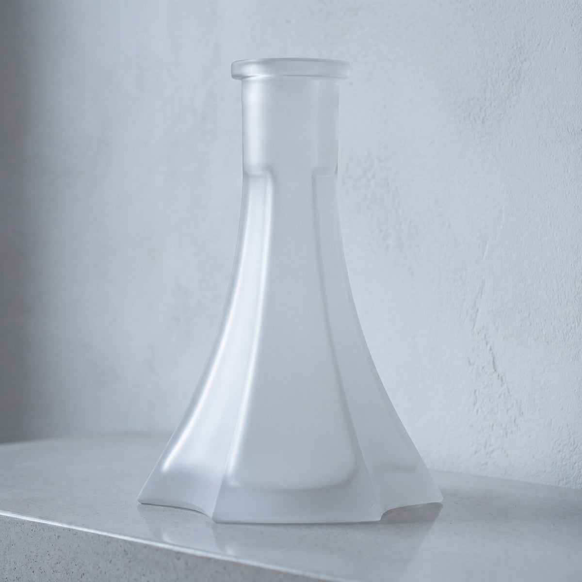 OVO x Neolux Frosty White frosted glass hookah base on pale concrete console in modern interior, The Premium Way, image 3 of 5