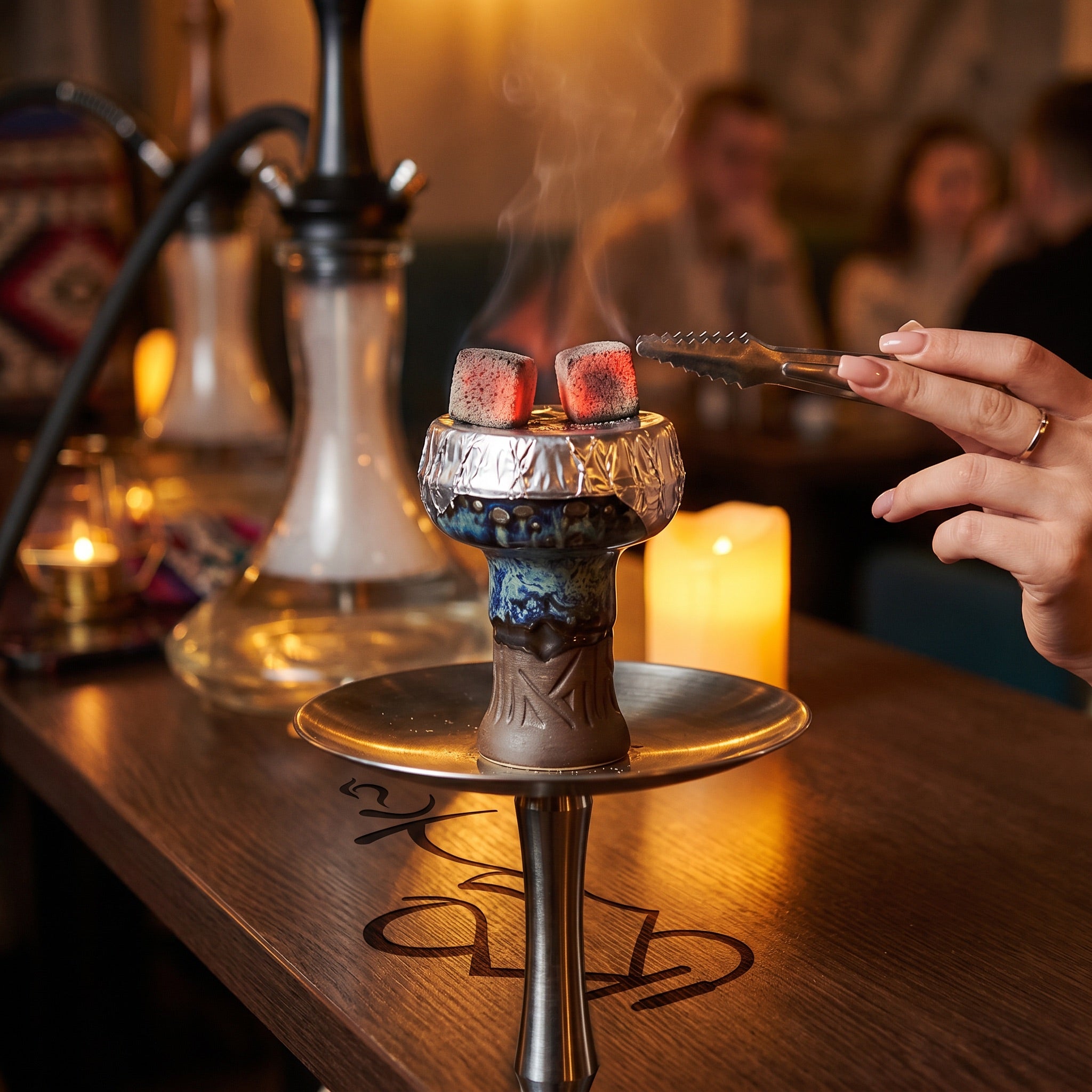Queen phunnel bowl in Frozen mid-session with foil and glowing coconut coals on a hookah setup, The Premium Way.