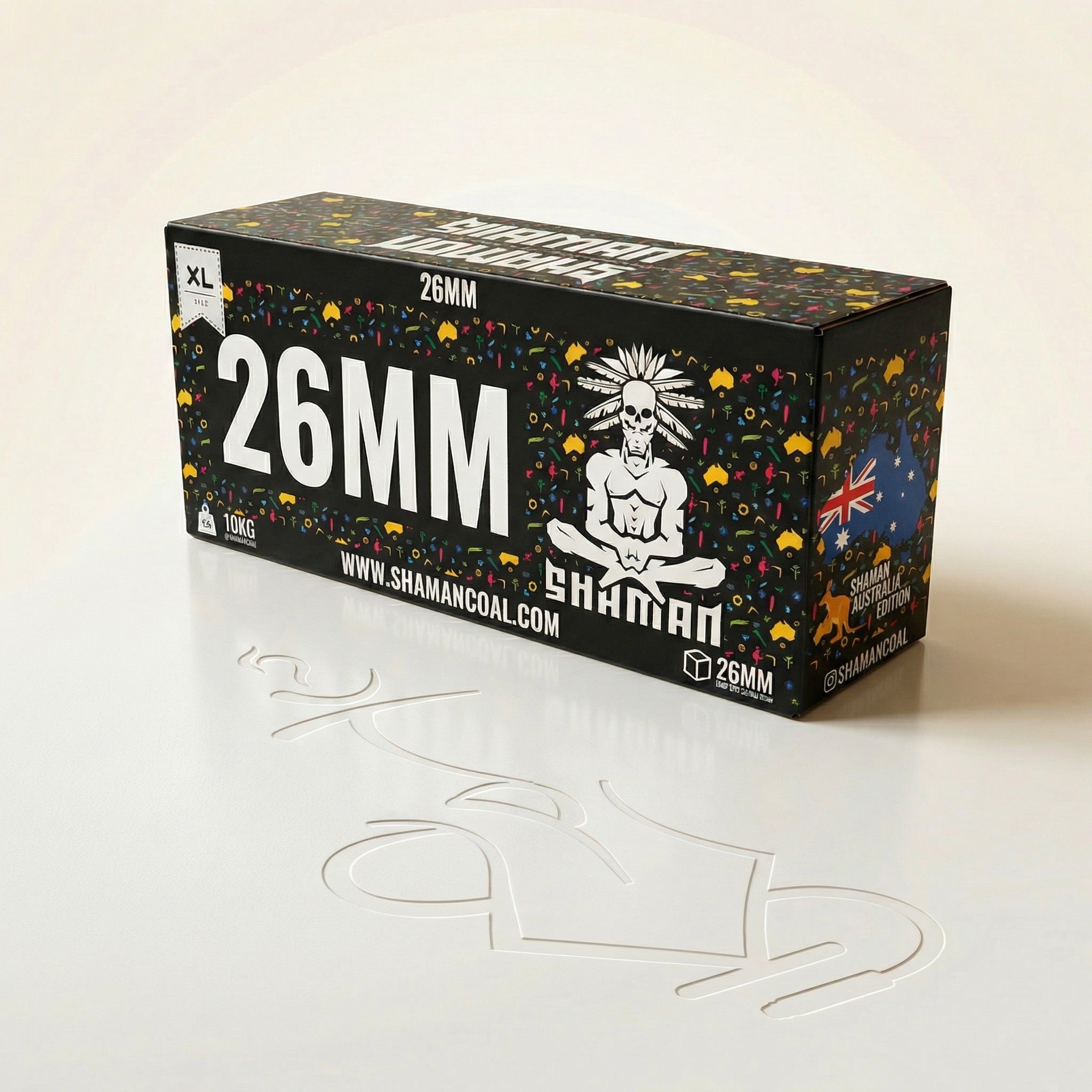 Shaman 26mm coconut charcoal 10kg master box at a three-quarter angle showing the front face and Australia Edition side panel in a professional studio setting.