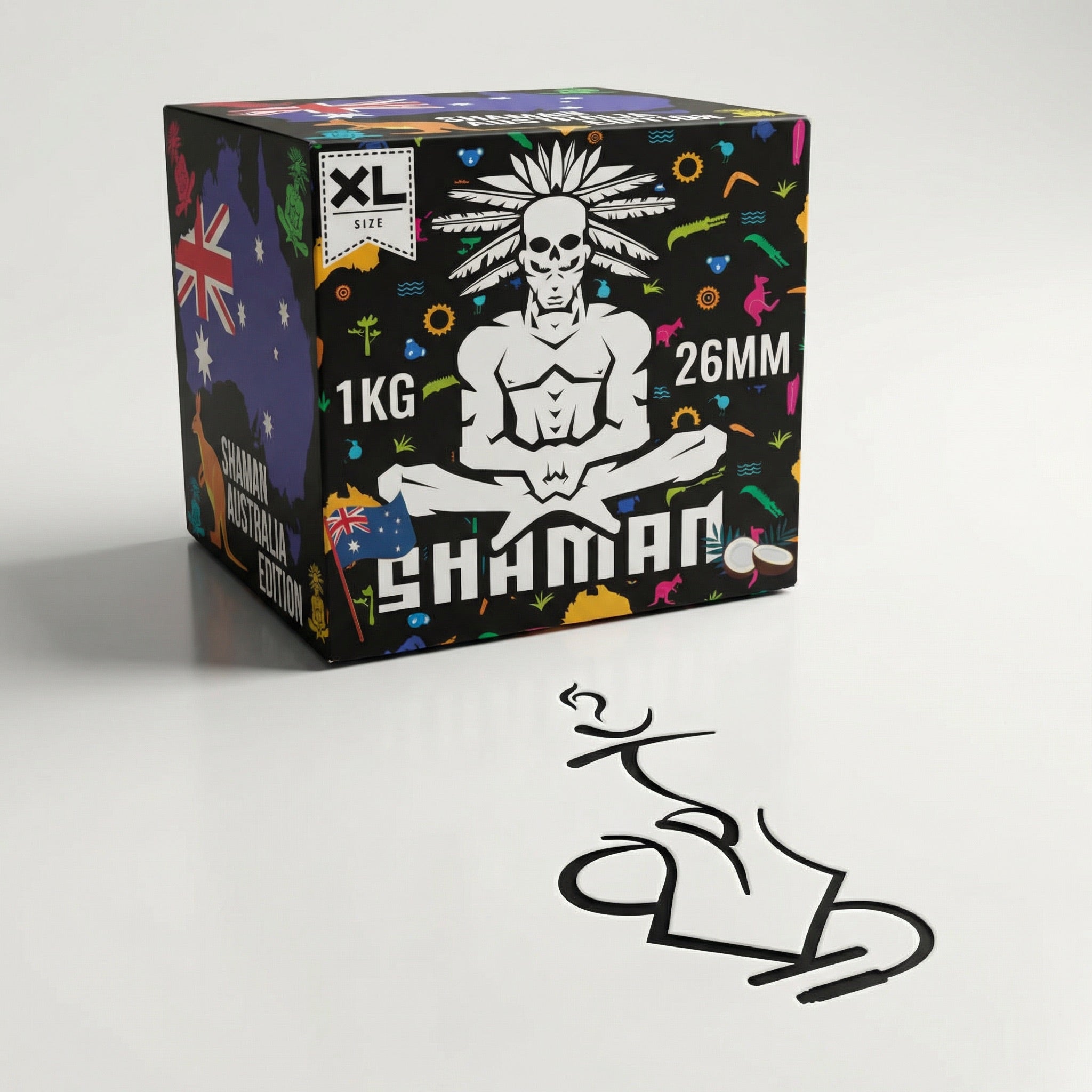Shaman 26mm coconut charcoal 1kg box at a three-quarter angle showing the skull mascot and Australia Edition panel in a professional studio setting.
