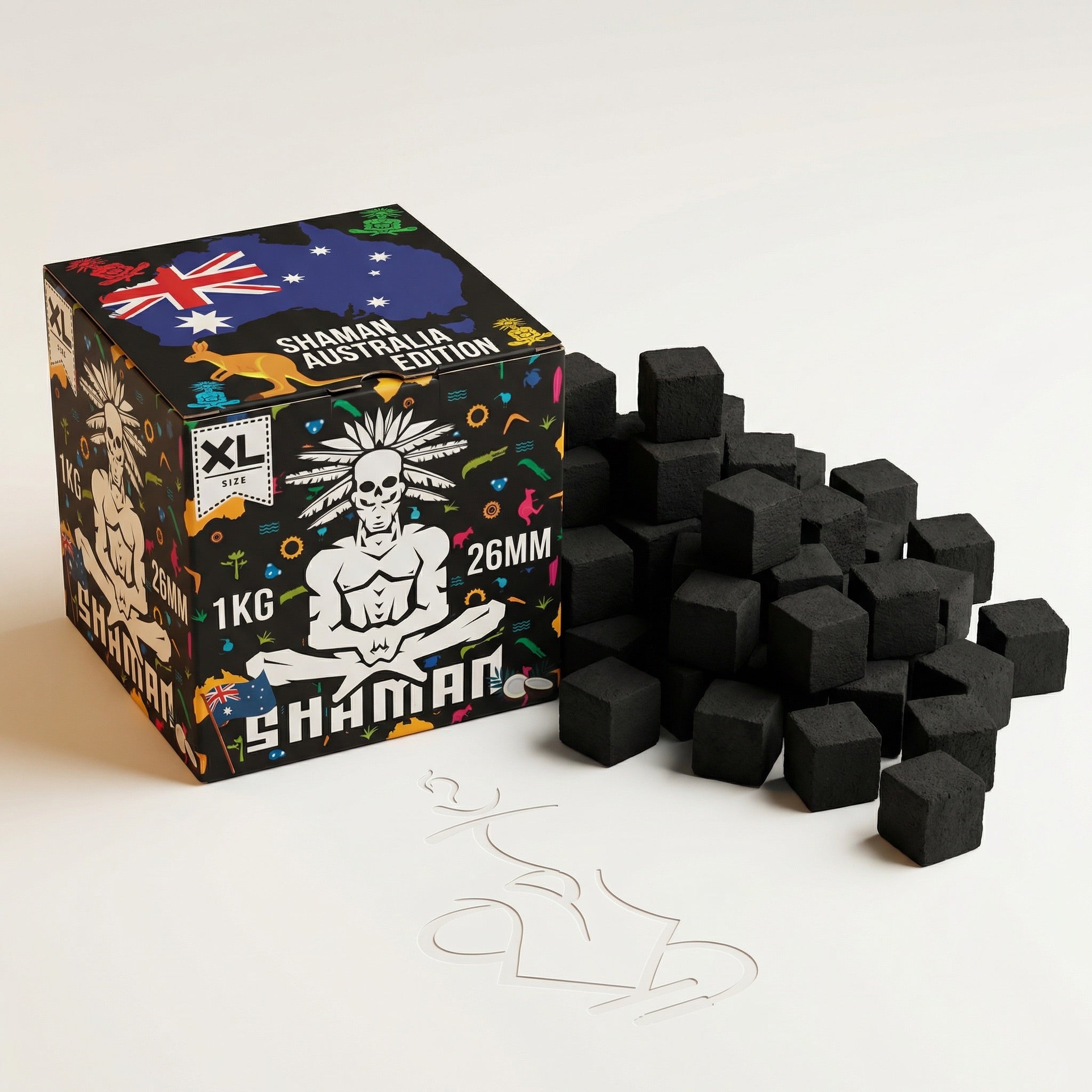 Shaman 26mm coconut charcoal 1kg box with a generous spread of loose pressed coconut shell cubes beside it in a professional studio setting.