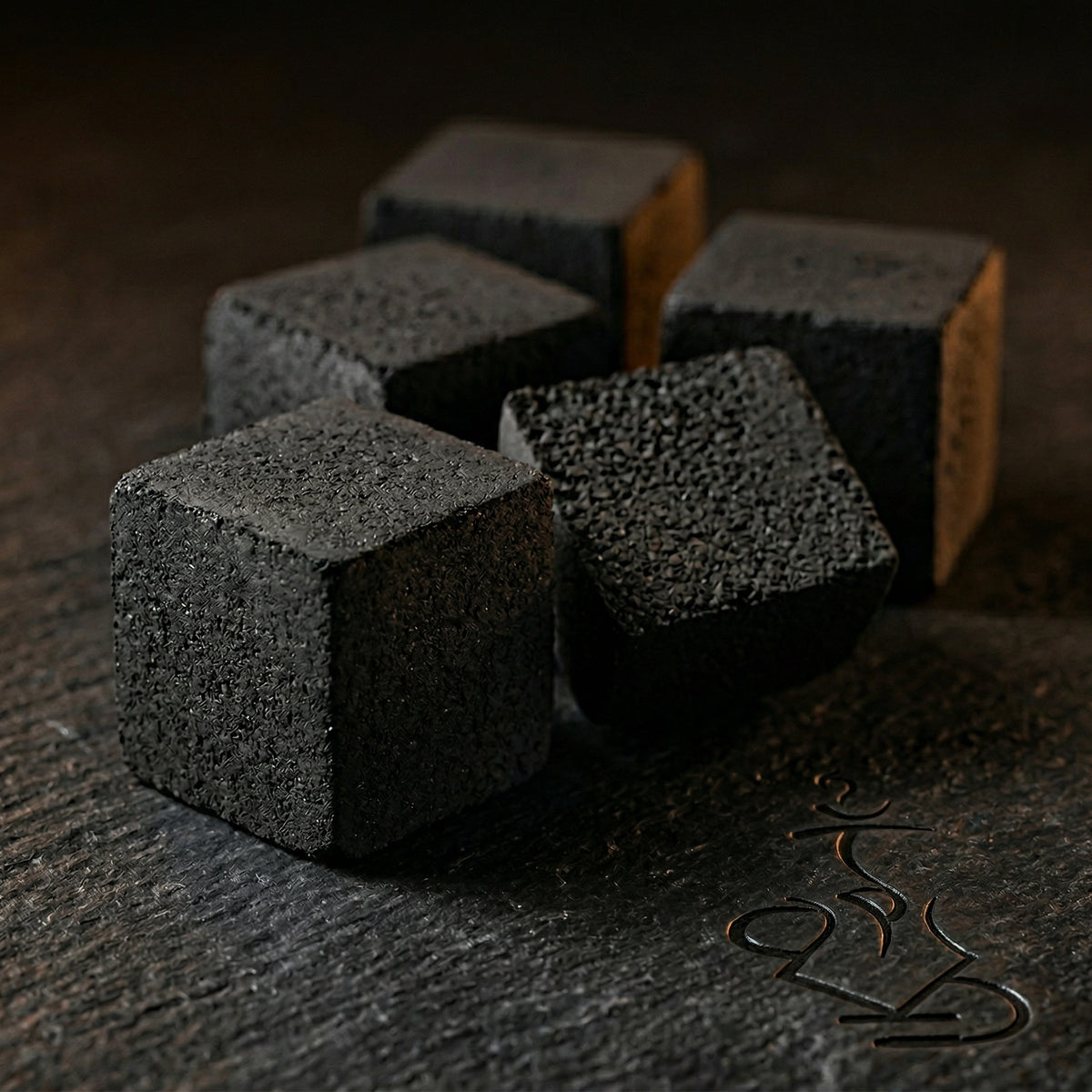 Shaman 28mm coconut charcoal cubes in macro close-up showing dense compressed granular texture and crisp squared edges on dark surface, image 8 of 10