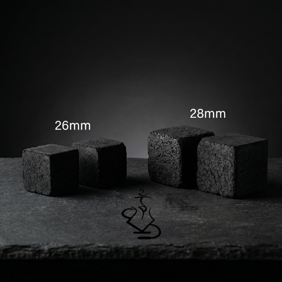 Shaman coconut charcoal size comparison showing smaller 26mm cubes next to larger 28mm XXL cubes on dark slate surface, image 7 of 10