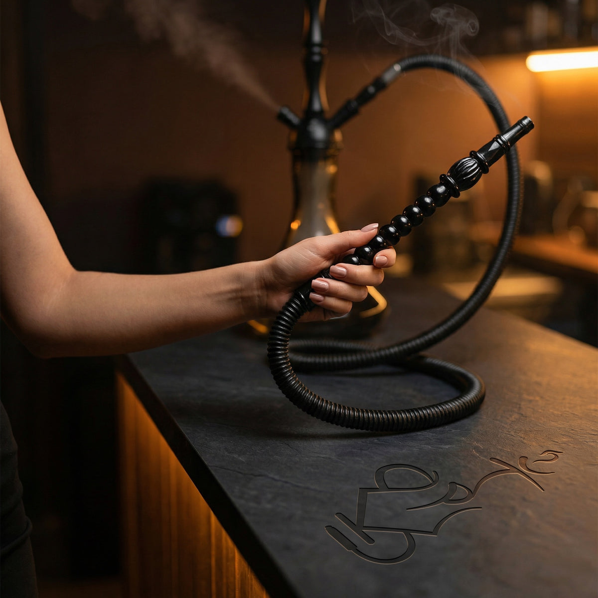 Hand holding ShishaDoc 1.8m disposable hookah hose ornamental handle during a hookah session in a warm lounge setting, image 3 of 10