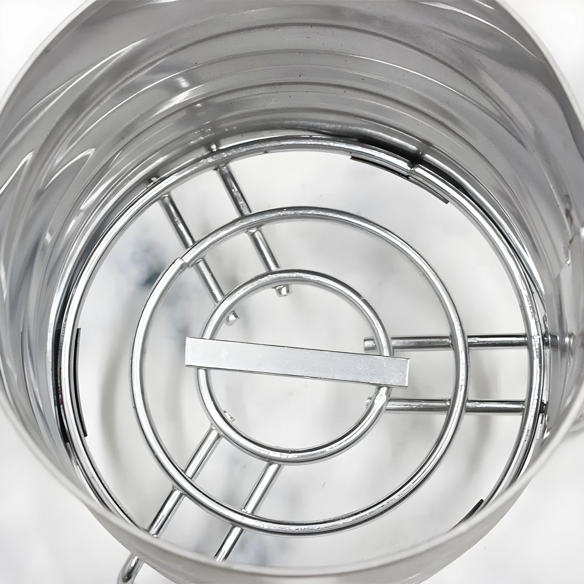 Close-up of stainless steel charcoal holder interior with grill structure, image 8 of 9