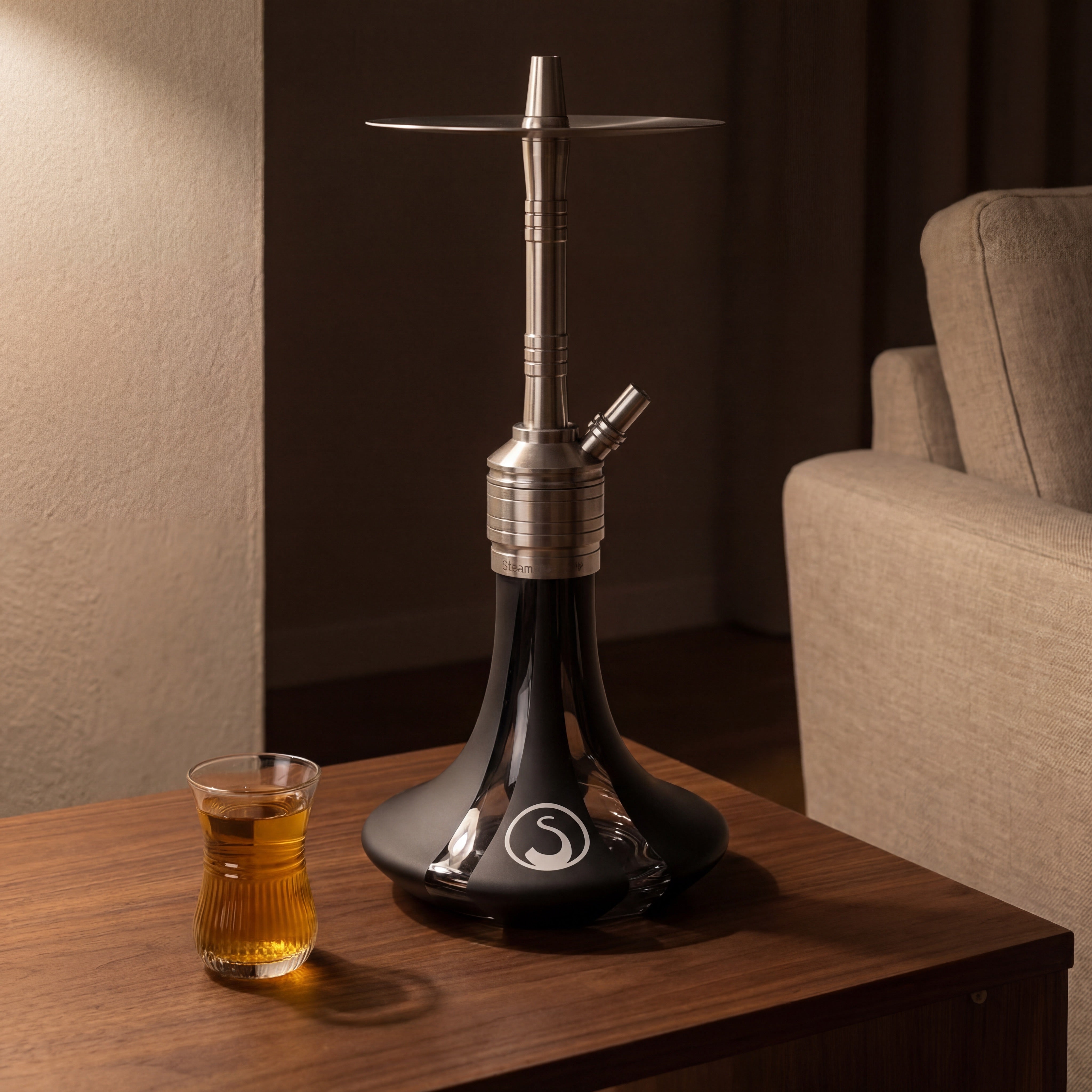 Steamulation Mini Gen II Black Matt hookah on walnut side table with Arabic tea glass, The Premium Way