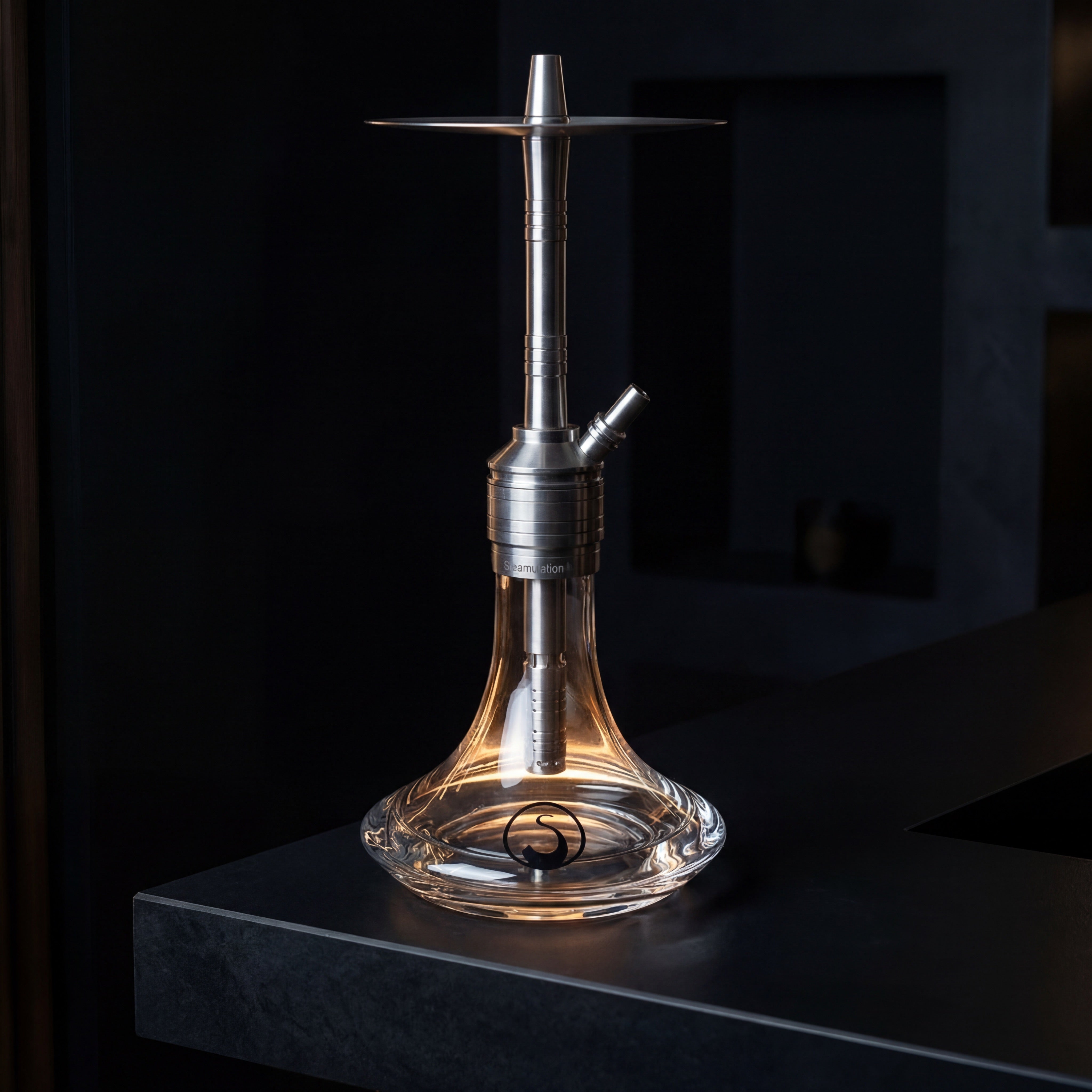Steamulation Mini Gen II Clear hookah on a dark bar counter, clear crystal base backlit with warm amber glow